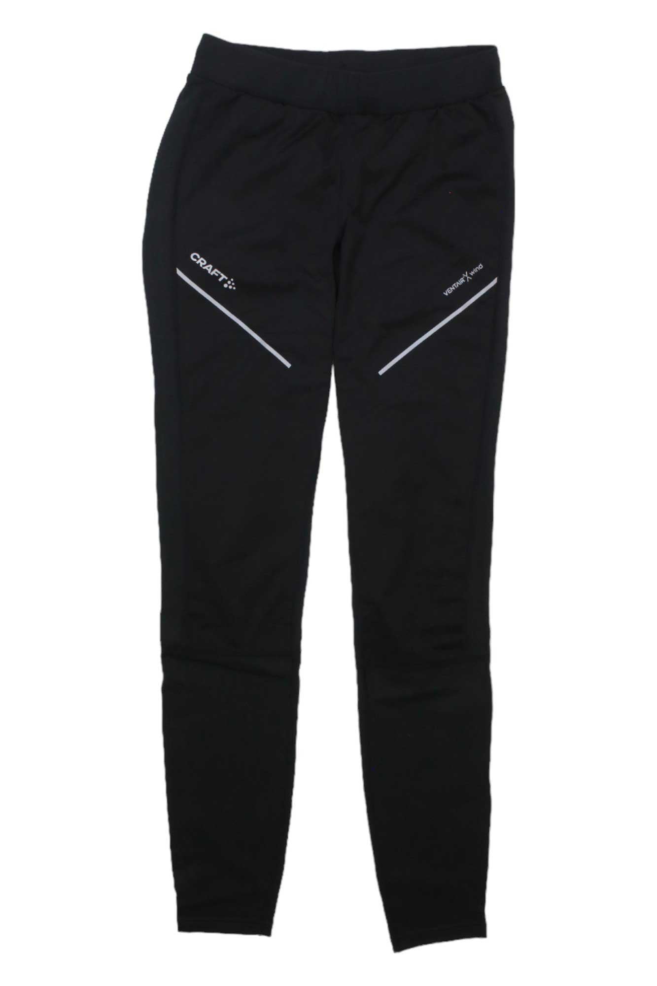 The Craft Sportswear Men's ADV Essence Wind Tight features a slim fit, angled white zippers, a small white logo on the upper thigh, and an elastic waistband. Made from stretchy, windproof, moisture-wicking fabric for comfort and style.