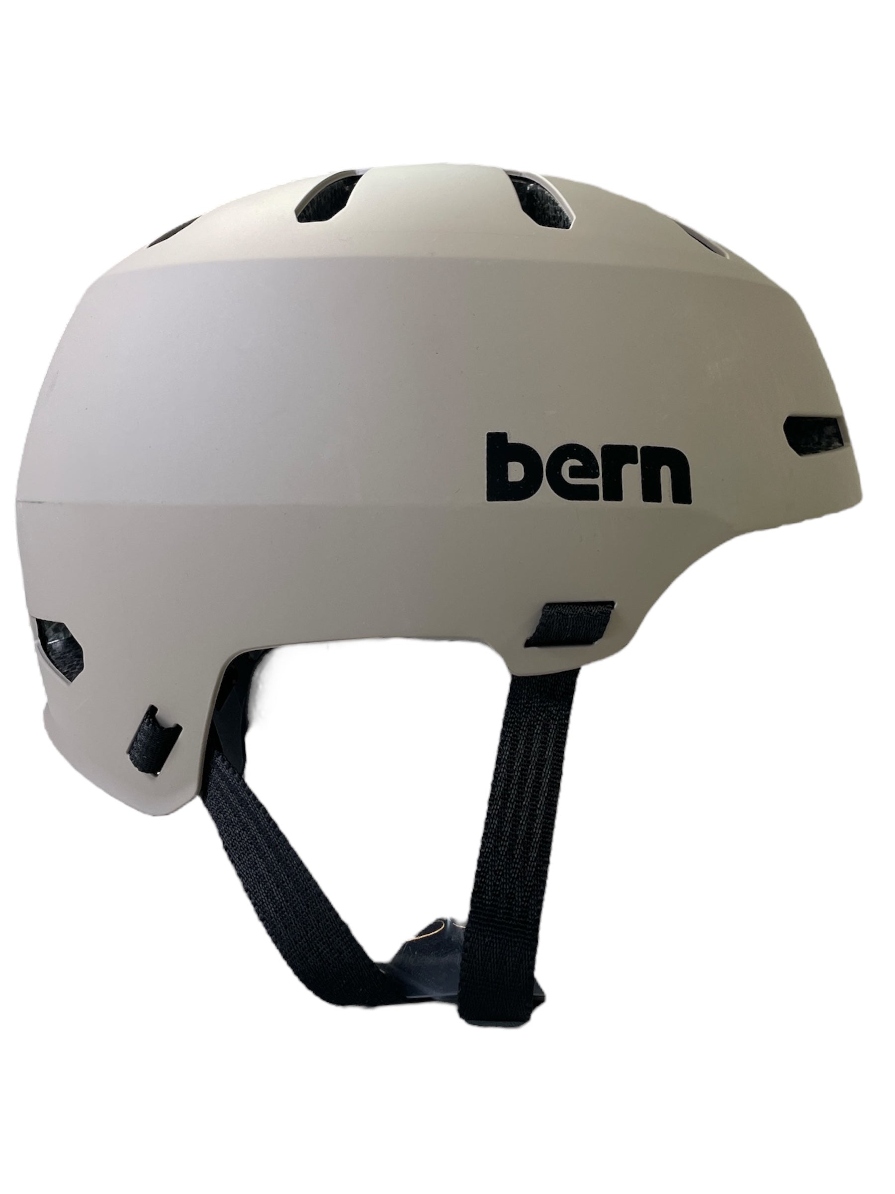The Bern Macon 2.0 MIPS Bike Helmet features a matte light gray finish, black ventilation holes, adjustable black straps, and a black bern logo—perfect for urban commuting or road cycling.