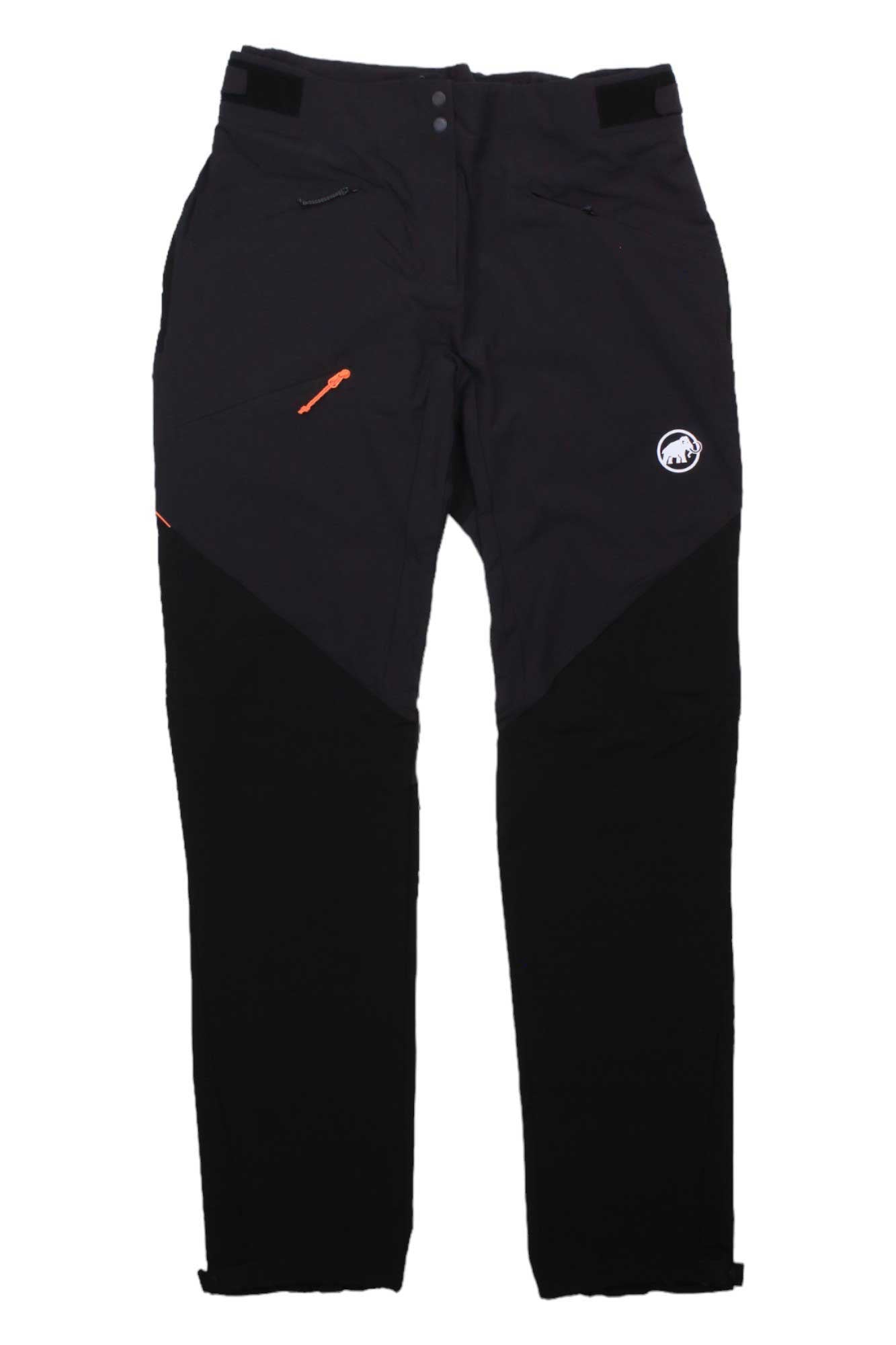 The Mammut Womens Courmayeur SO Pant for Black women features zippered pockets, an embroidered thigh logo, and reinforced knee patches, shown laid flat on a white background.