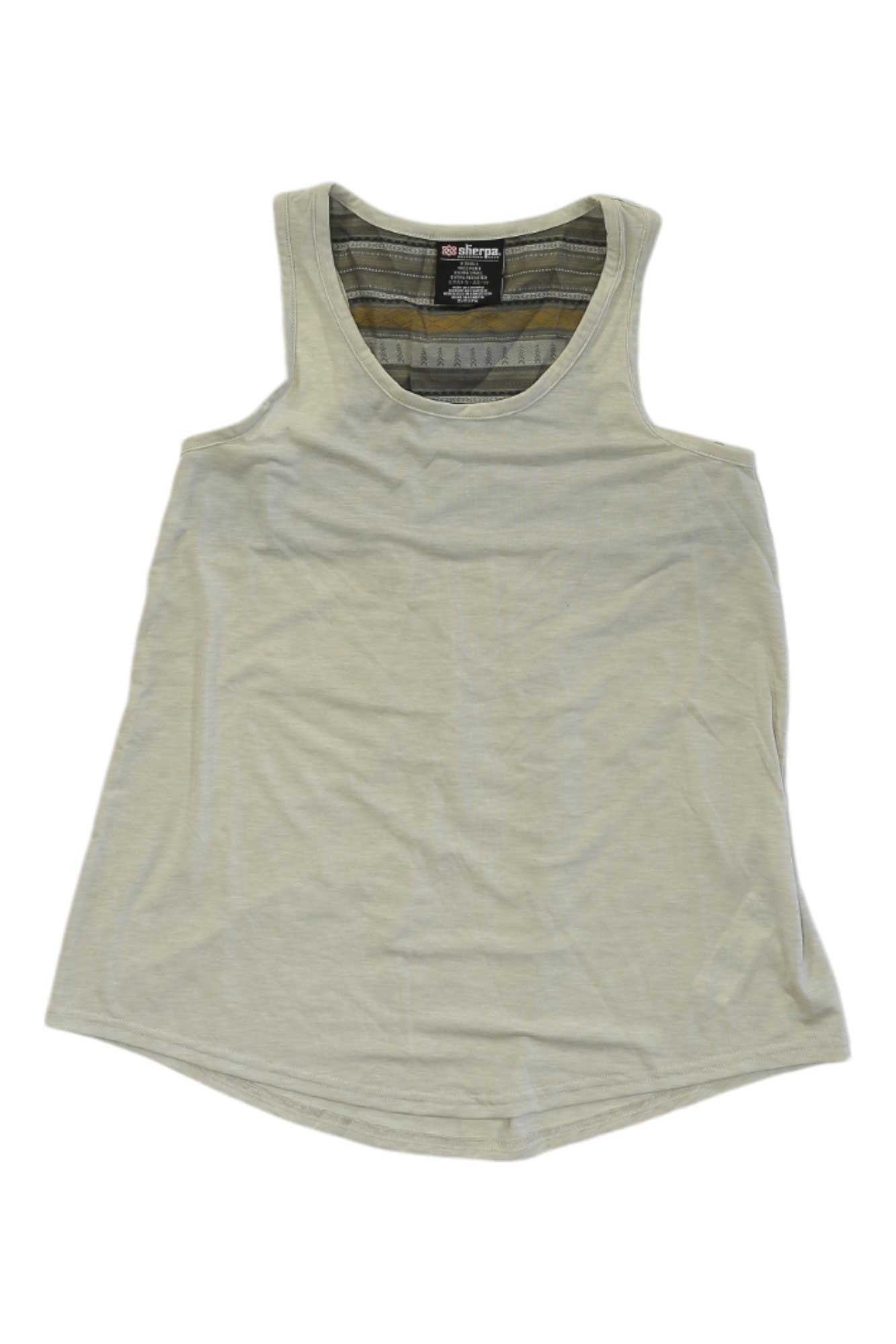 The Sherpa Womens Asha Tank is a sleeveless, light beige top with a round neckline, made from soft drirelease fabric for moisture wicking. Shown flat on white, its inside back collar shows a visible clothing label.