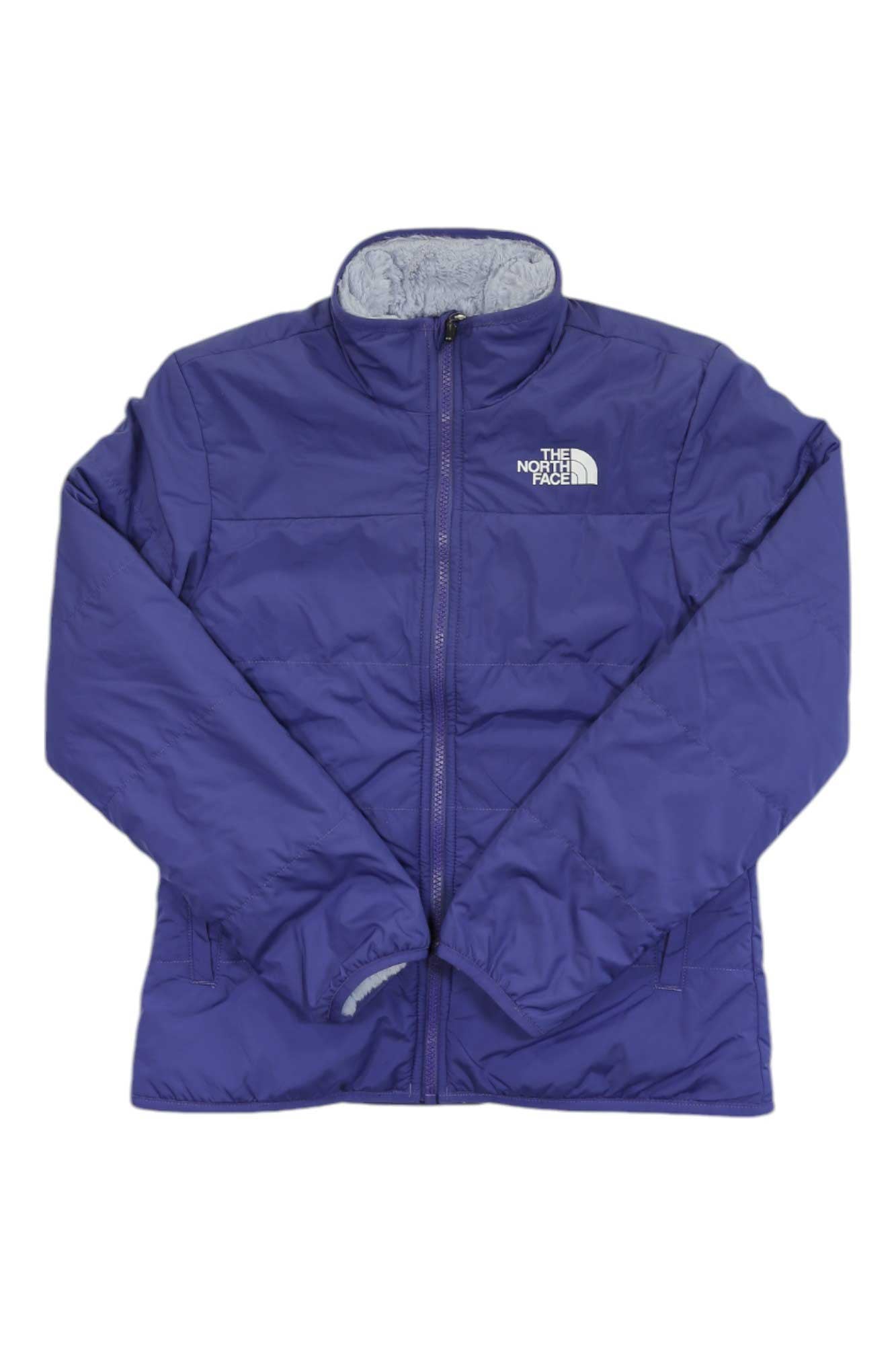 Purple The North Face Girls Reversible Mossbud Jacket featuring a front zipper, long sleeves, and the brand’s white logo on the left chest, laid flat on a white background.