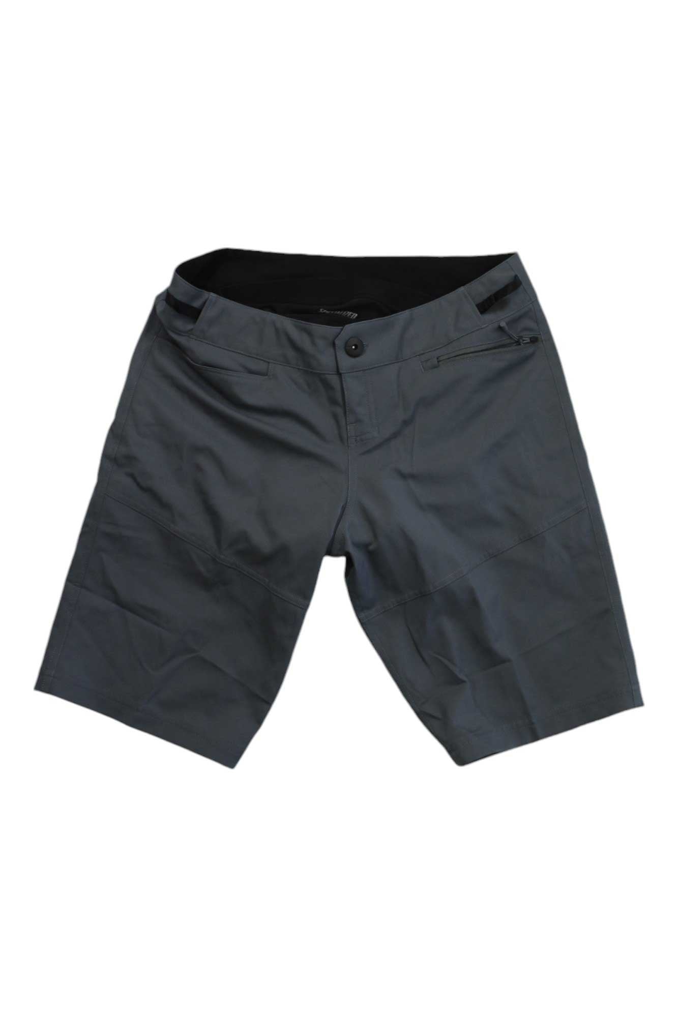 The SPECIALIZED WOMENS TRAIL SHORT WITH LINER is a pair of dark gray women’s trail shorts with a button and zip fly, belt loops, and a right-side zippered pocket—ideal mountain bike shorts for your next adventure.