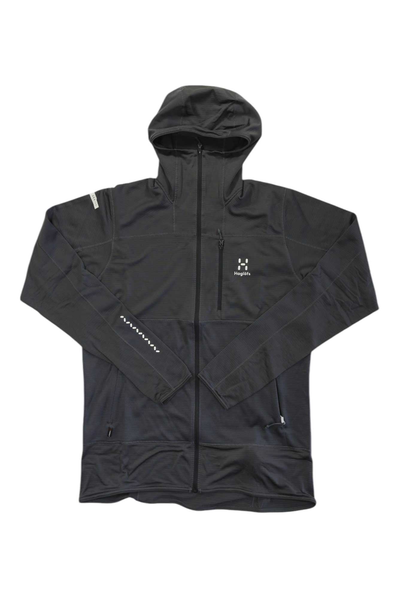 The Haglofs Men's L.I.M Mid Fast Hoodie in black is shown on a white background, featuring a full front zipper, moisture-wicking Polartec Power Grid fabric, zippered chest and side pockets, and a white logo on the chest.