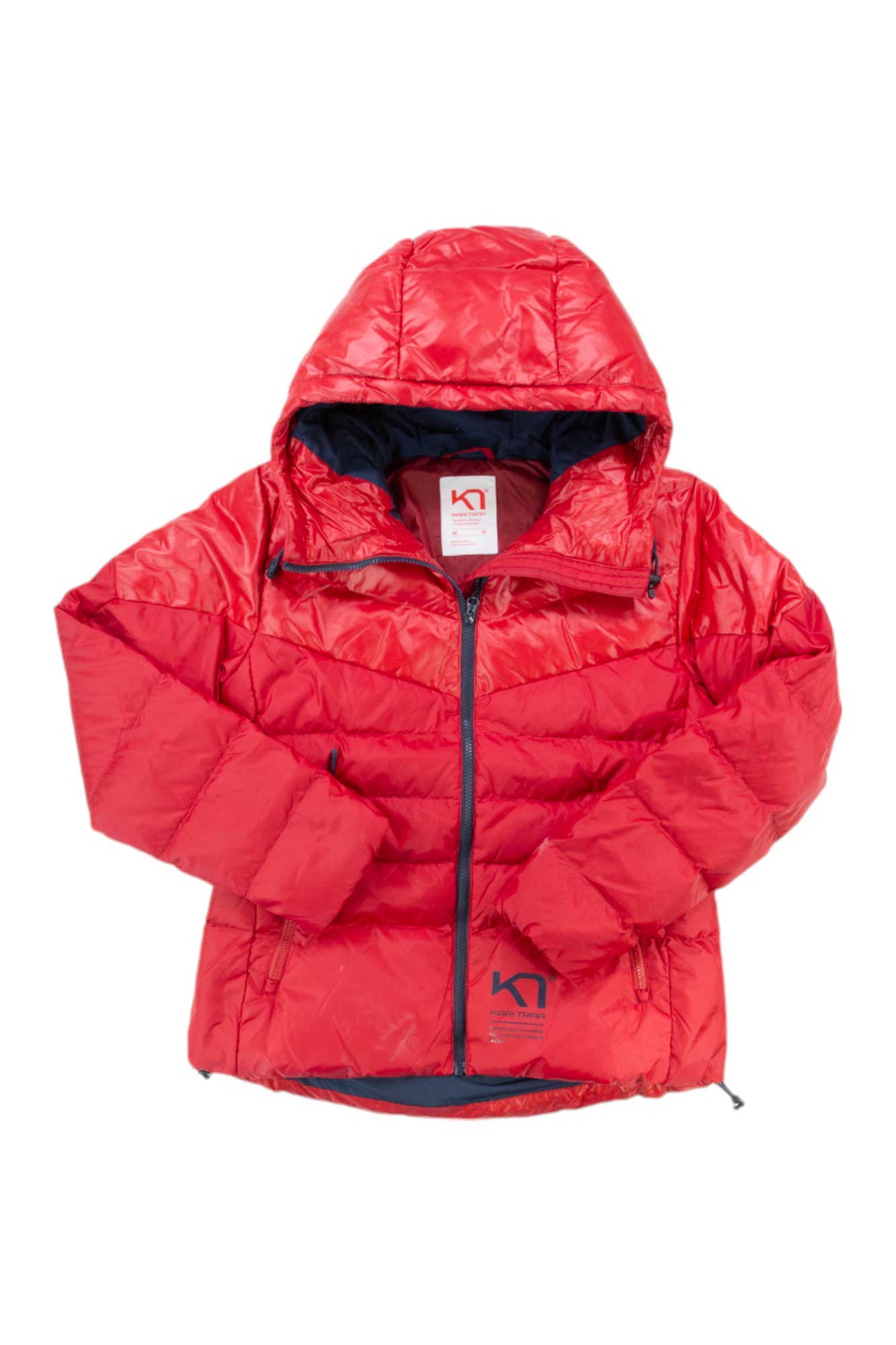 The Kari Traa Womens Tirill Down Jacket is a bright red, hooded, insulated down puffer with a front zipper, folded sleeves, inner collar brand tag, padded and water-repellent—built for cold weather and outdoor use.