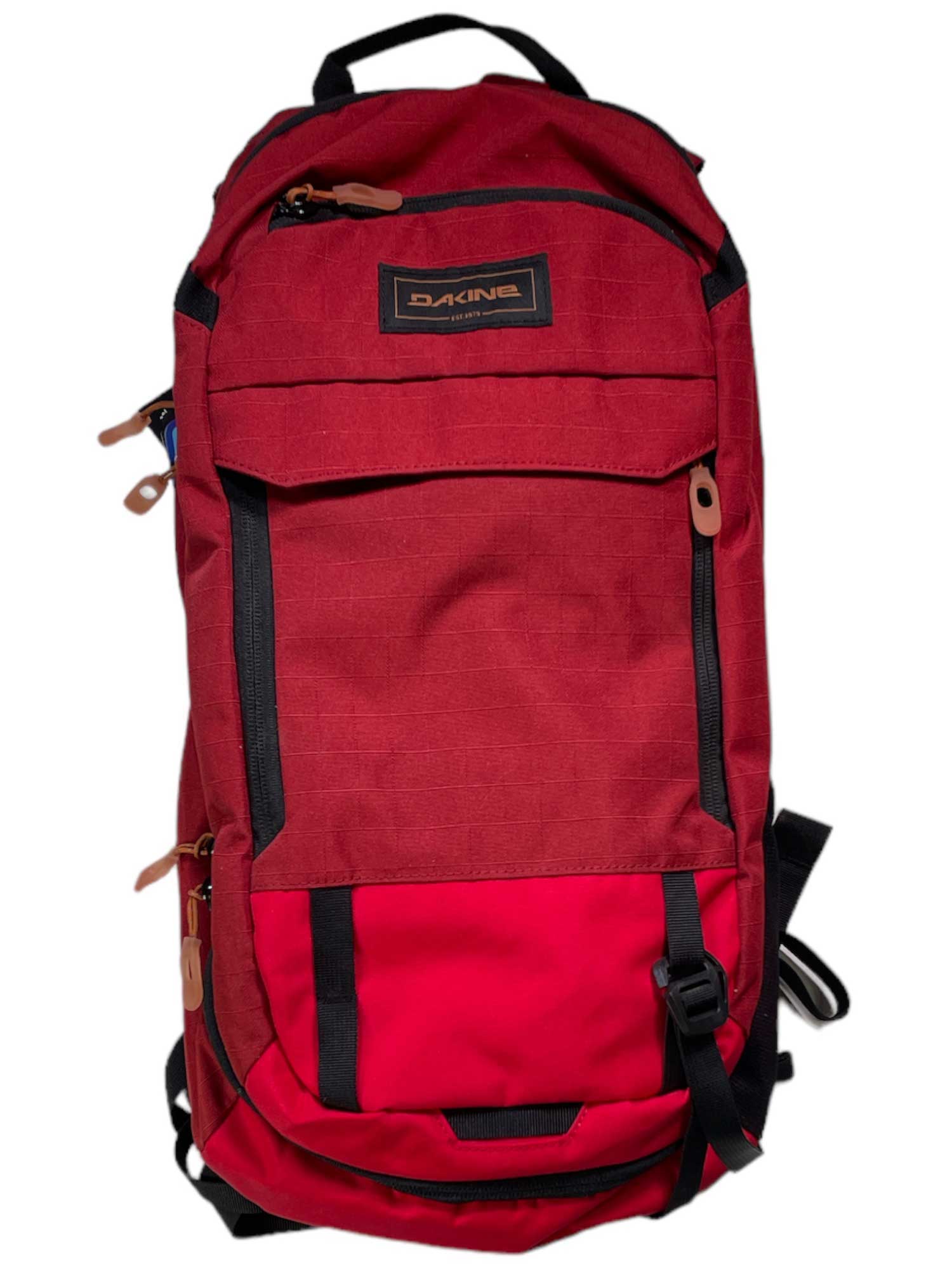 The Dakine Syncline 12L Hydration Pack, shown in red with black zippers, tan pulls, and a front pocket on a white background, is spine protector compatible for safer mountain biking adventures.