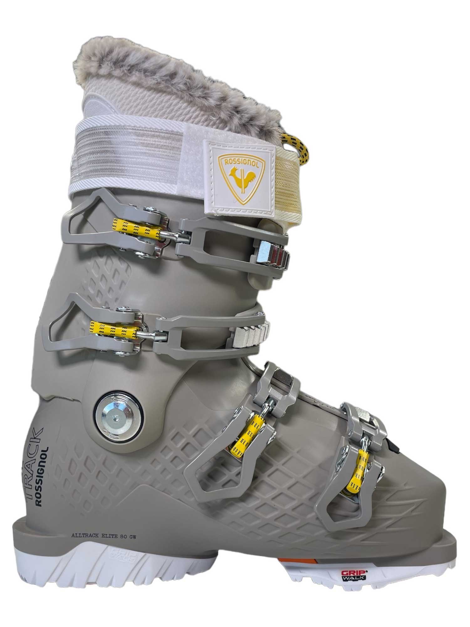 The Rossignol Alltrack Elite80 GW W Ski Boot, shown in profile, features a gray design with white and yellow accents, three metal buckles, a furry liner, and textured sole—engineered for comfort and custom fit.