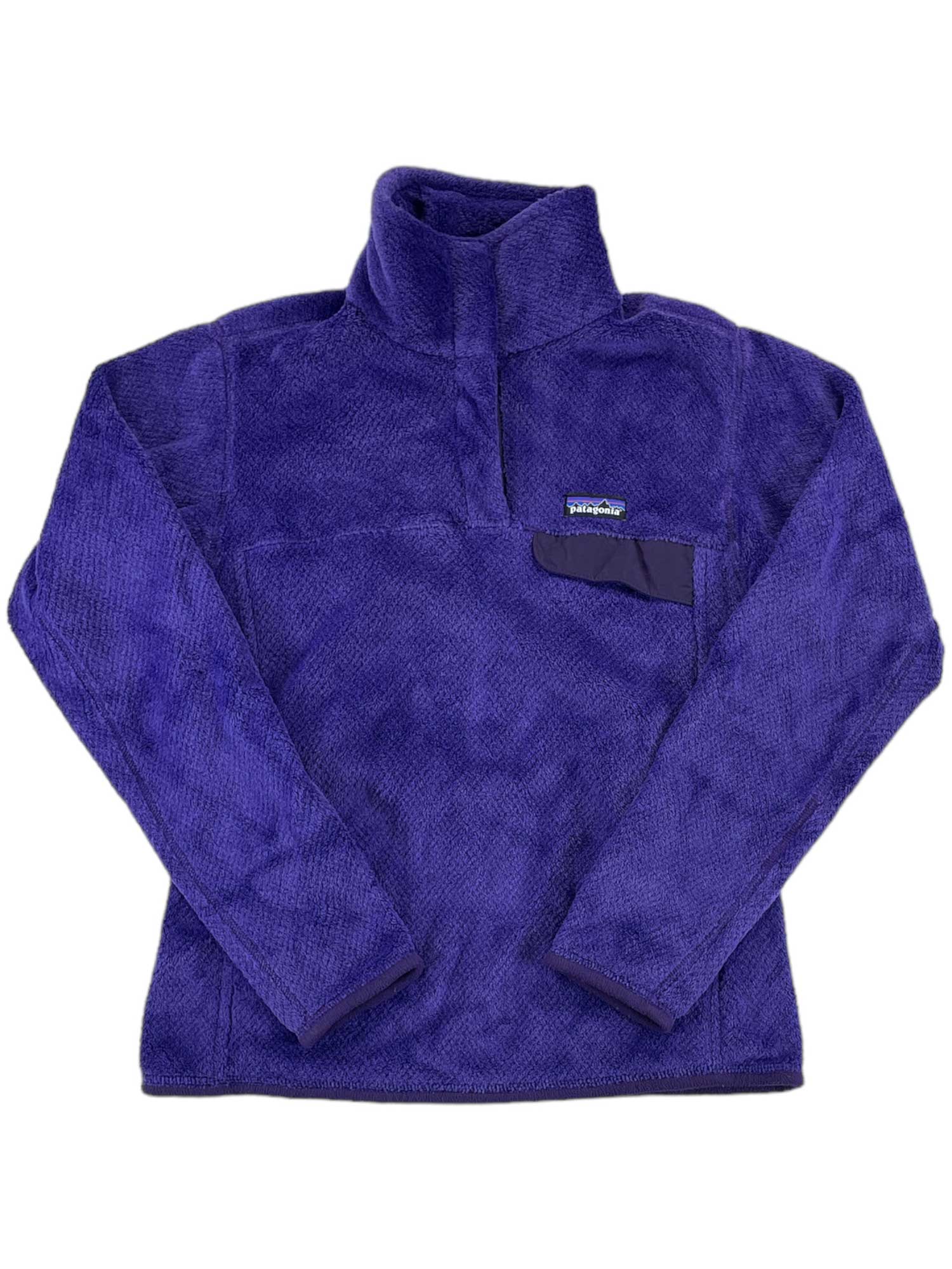 The Women's Re-Tool Snap-T Pullover is a purple, long-sleeve Polartec Thermal Pro fleece with a high collar, small chest pocket with Patagonia logo patch, soft textured look, recycled polyester, and Fair Trade Certified.