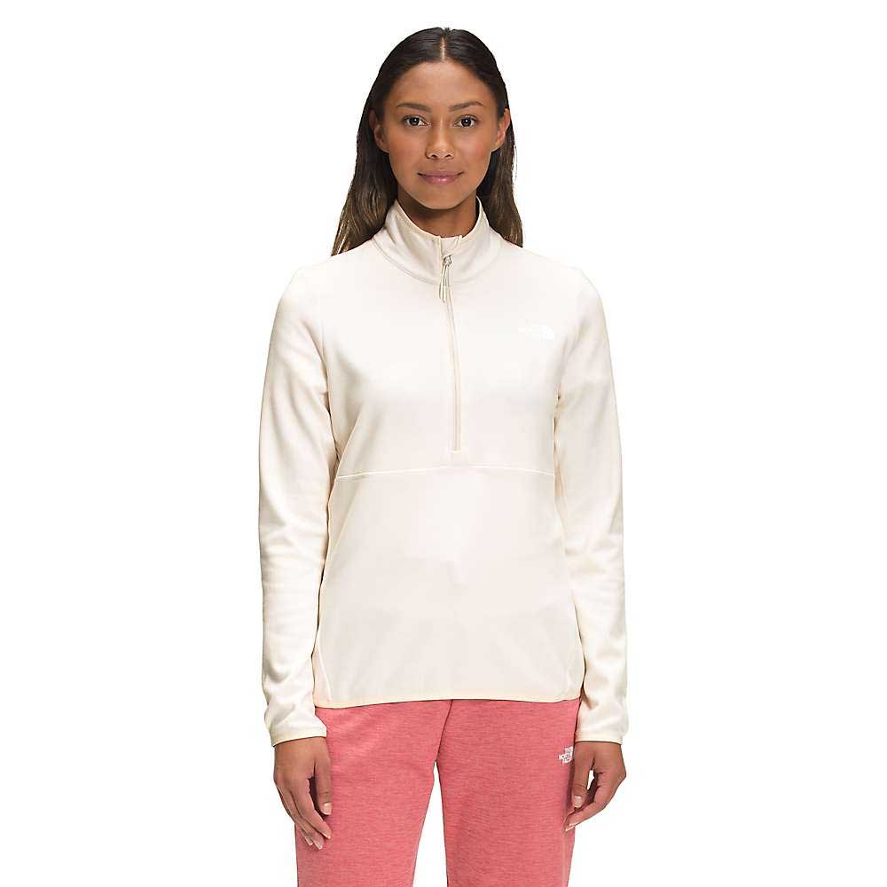 A woman with long brown hair and a neutral expression faces forward in The North Face Womens Canyonlands 1/4 Zip Top, paired with cream and pink jogger pants, posing against a white background.