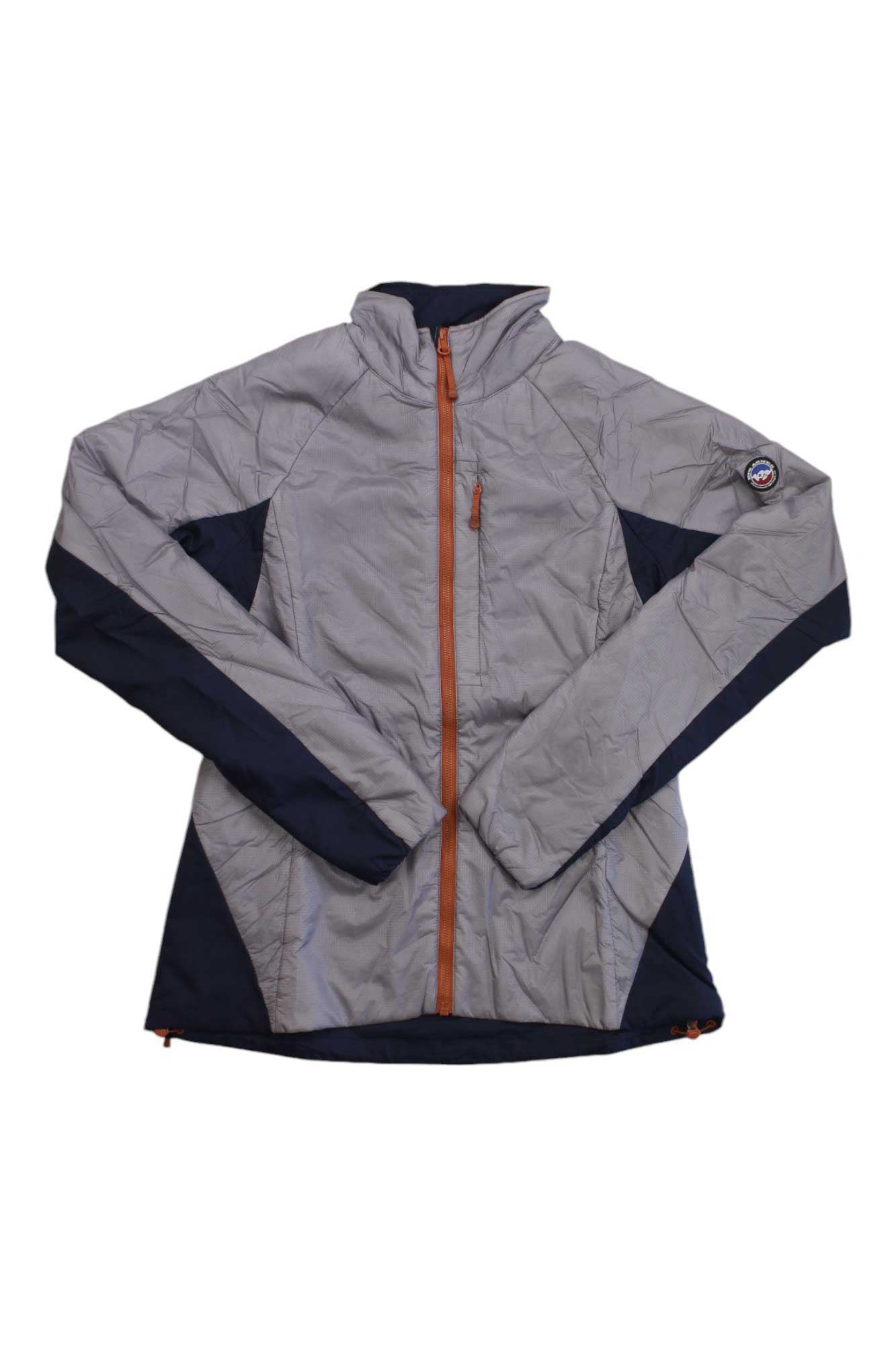 The Big Agnes Womens Crystal Jacket features light gray and navy blue colors, an orange zipper, a small chest pocket, 4-way stretch fabric, long sleeves, and a round logo patch on the upper left arm for style and comfort.
