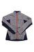 The Big Agnes Womens Crystal Jacket features light gray and navy blue colors, an orange zipper, a small chest pocket, 4-way stretch fabric, long sleeves, and a round logo patch on the upper left arm for style and comfort.