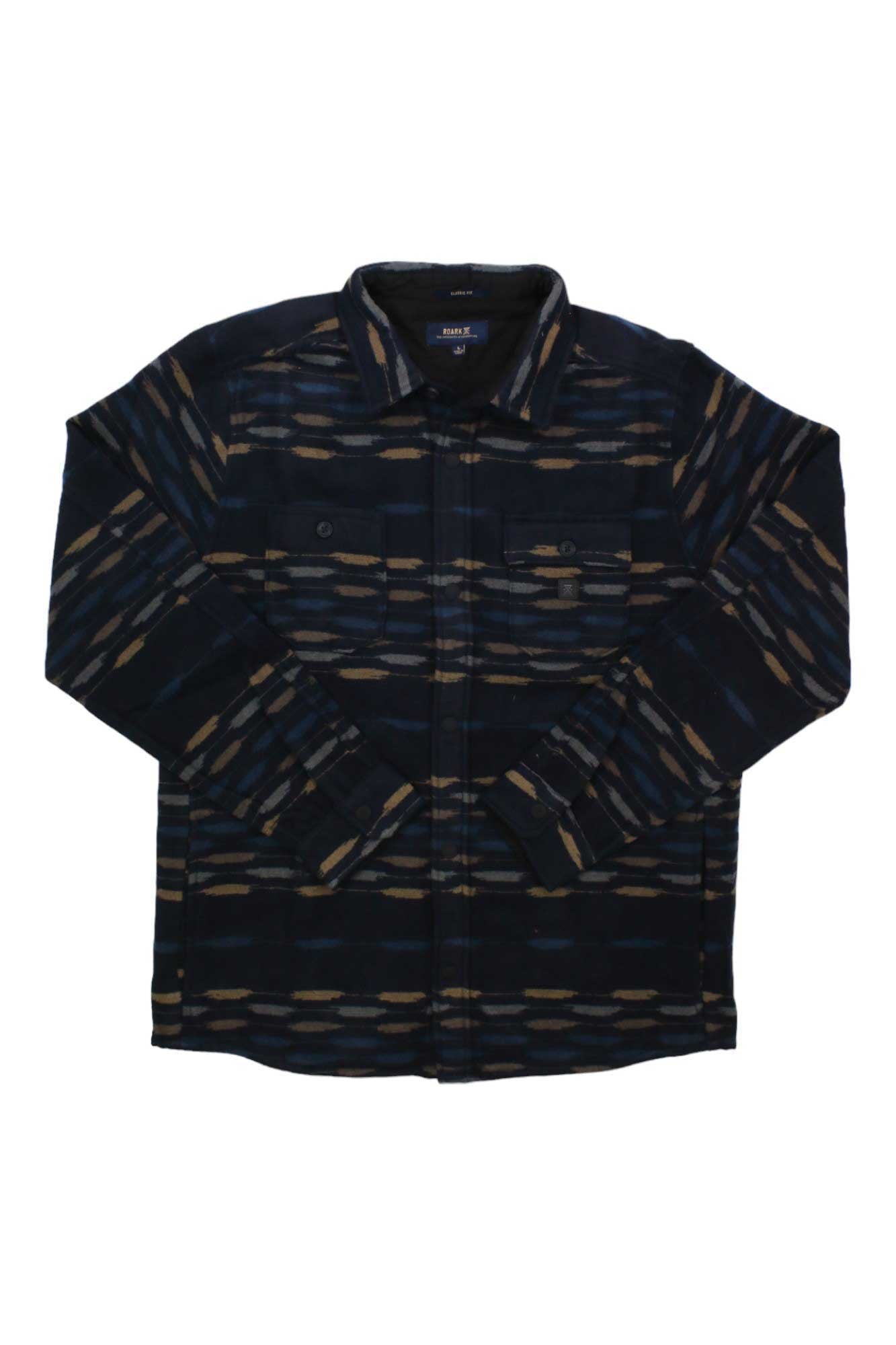 The Roark Men's Andes Shirt is a heavyweight flannel overshirt with long sleeves, a collar, two chest pockets, and a dark base featuring an abstract brown, tan, and blue horizontal pattern—ideal for casual layering or travel.