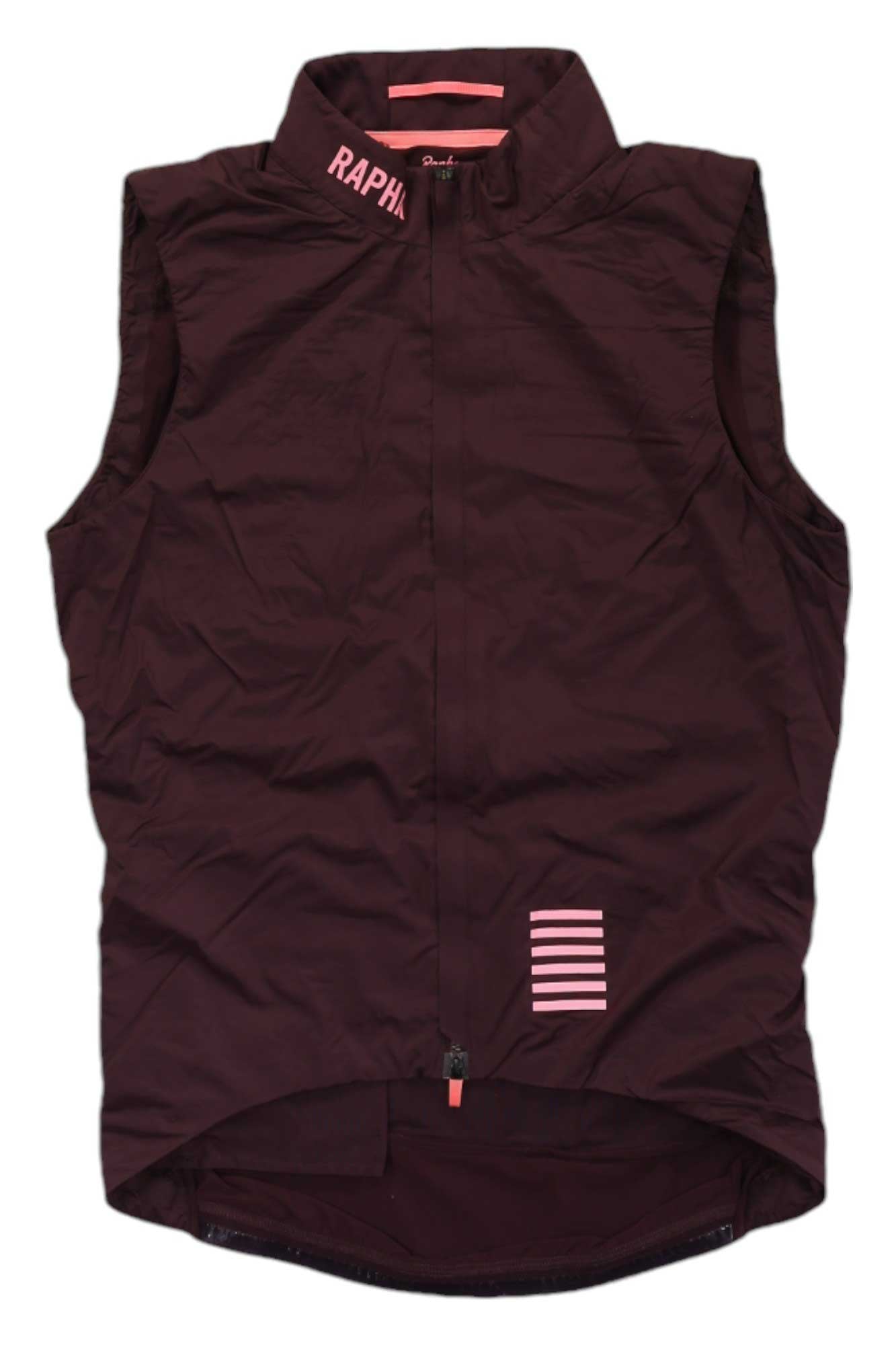 The Rapha Men's Pro Team Insulated Gilet is a sleeveless, dark maroon cycling vest with a high collar, front zipper, RAPHA logo on the collar, and pink horizontal stripes near the hem.