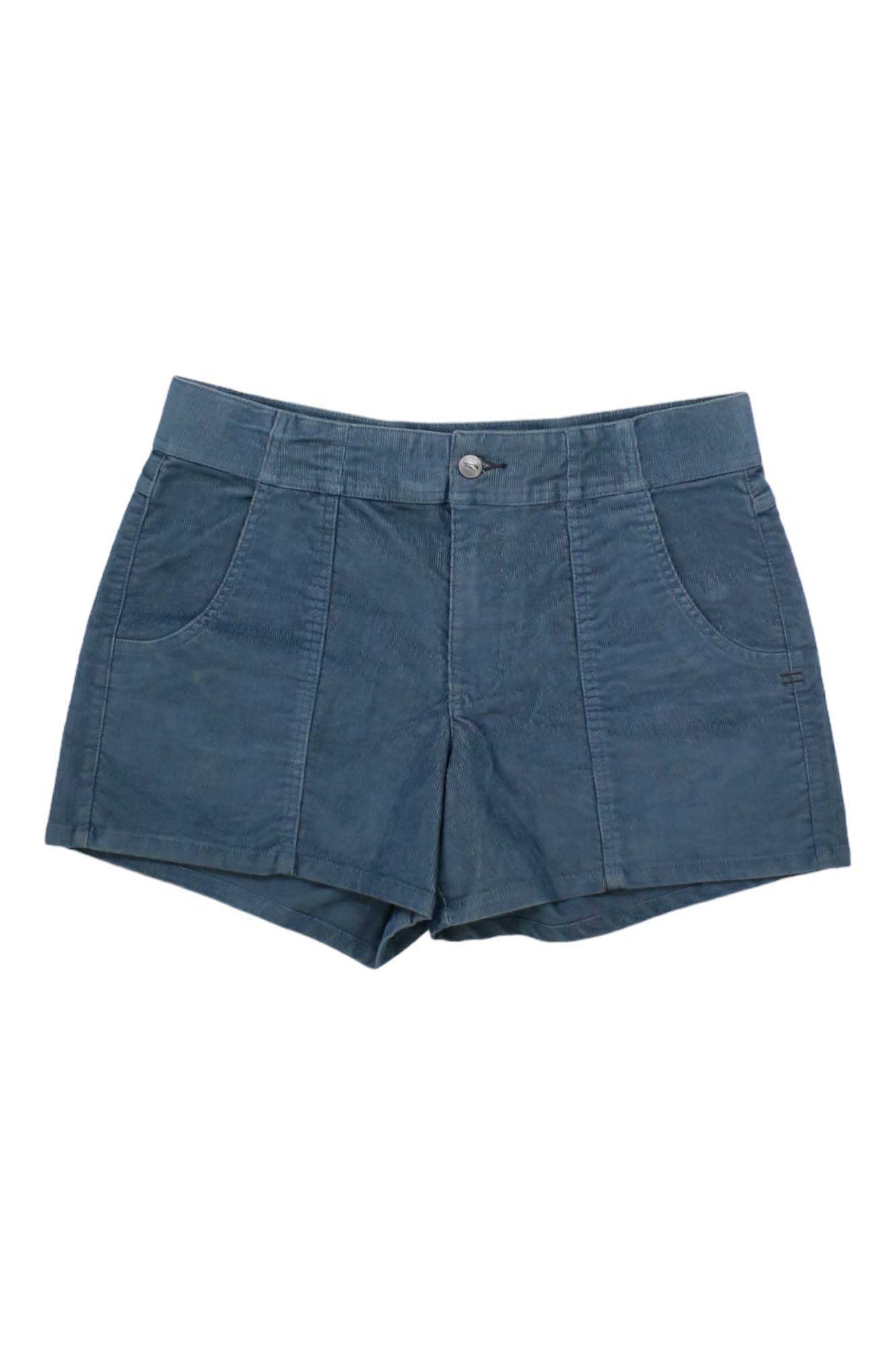 The Toad & Co Womens Coaster Cord 4 Inch Short is a blue corduroy casual short with a front button and zip closure, two front pockets, and a flat waistband. Made from moisture-wicking fabric for everyday comfort. Laid flat on a white background.