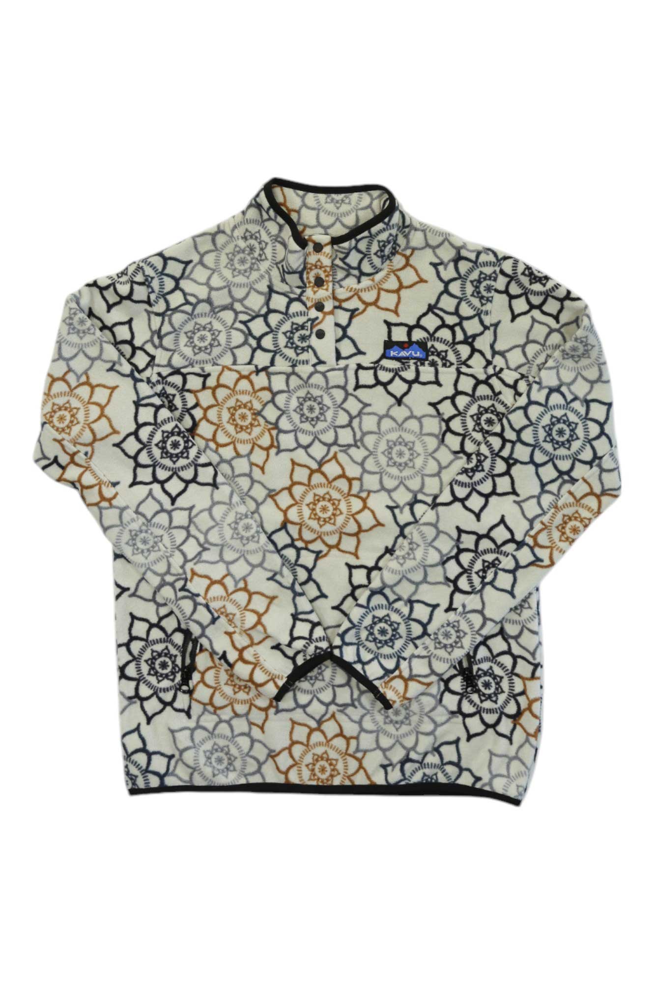 The KAVU Womens Cavanaugh Pullover is a cream, long-sleeve polyester fleece with a geometric floral pattern in brown, black, and gray. It features a short buttoned collar and a blue logo patch on the chest.