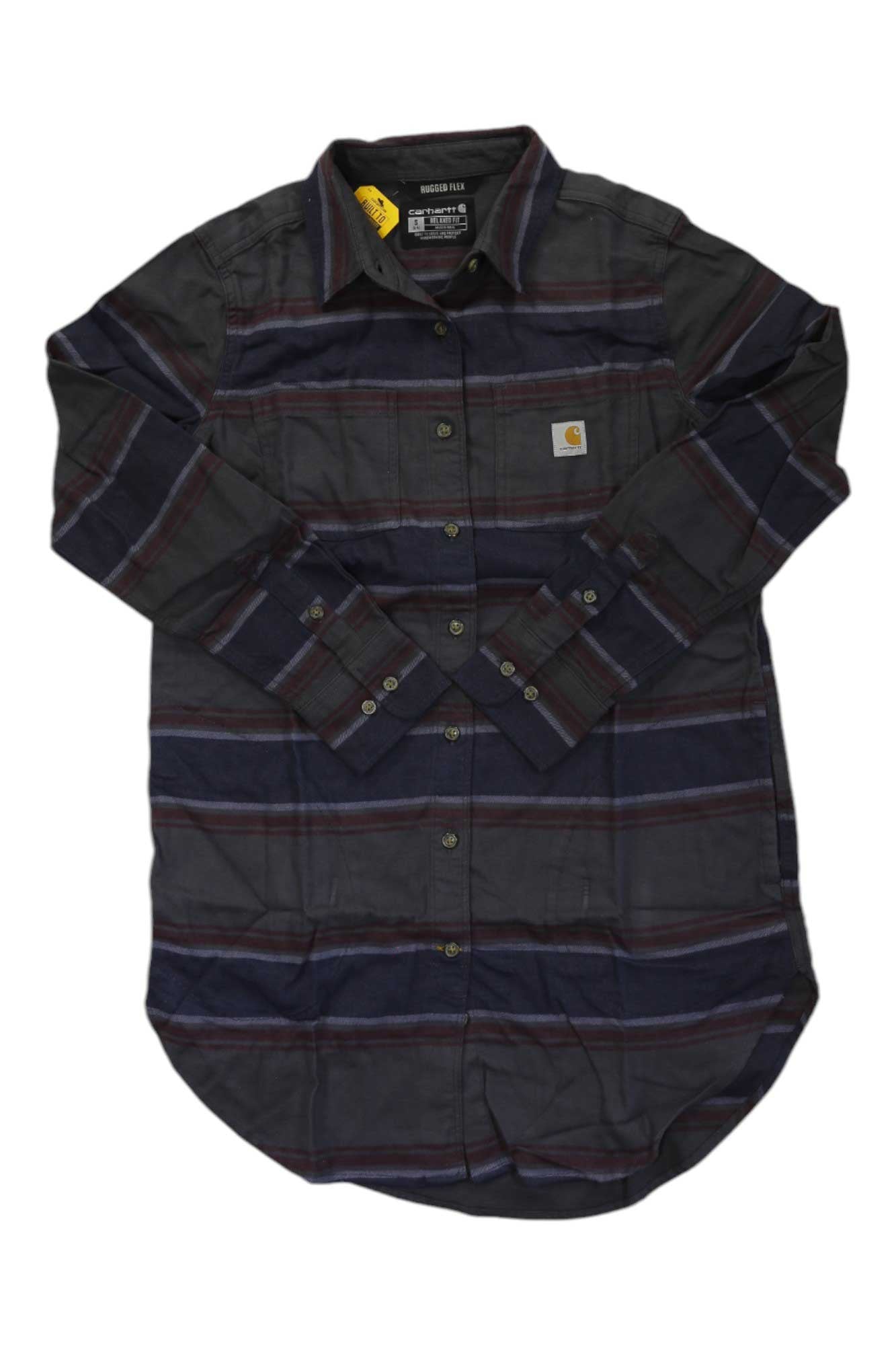 The Carhartt Womens Rugged Flex Relaxed Fit Midweight Flannel LS Plaid Tunic features dark purple, navy, and gray stripes, a chest pocket with logo patch, yellow collar tag, button-up front, tunic style, and stretch for comfort.