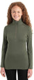 A woman with long curly red hair smiles, wearing the Icebreaker Womens 260 Tech LS Half Zip Top in olive green and black pants against a white background—an effortlessly stylish choice for outdoor wear.