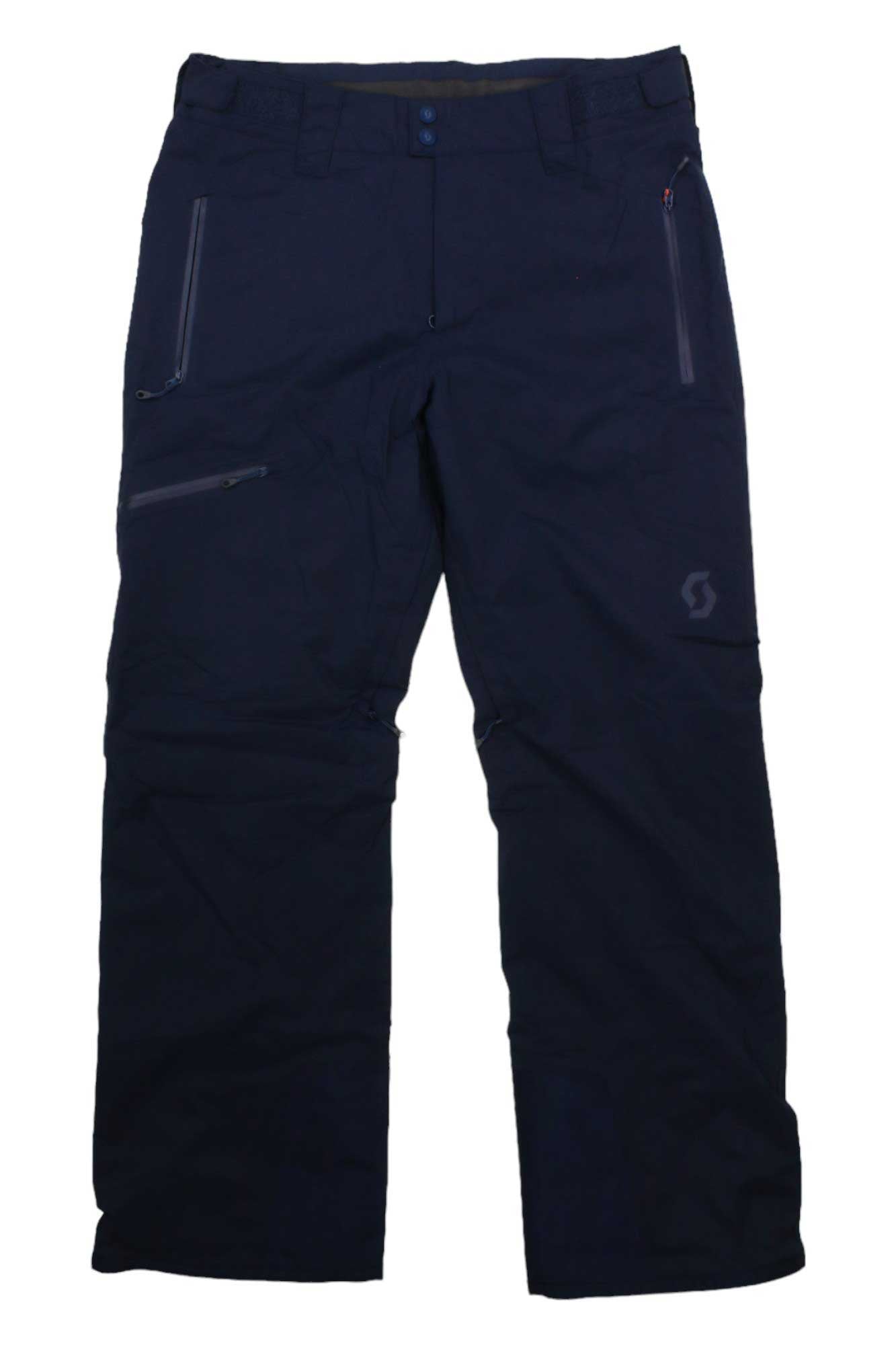 Scott USA Men's Ultimate DRX Pant in dark navy blue, insulated, features zippered side pockets and a button waist closure, shown laid flat on a white background.