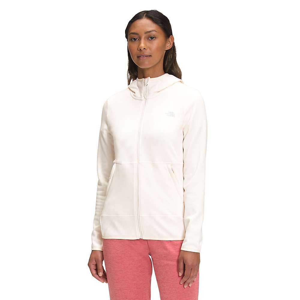 A woman wears The North Face Womens Canyonlands Hoodie in light cream, featuring a hood and front pockets, with pink pants, standing facing forward against a plain white background.