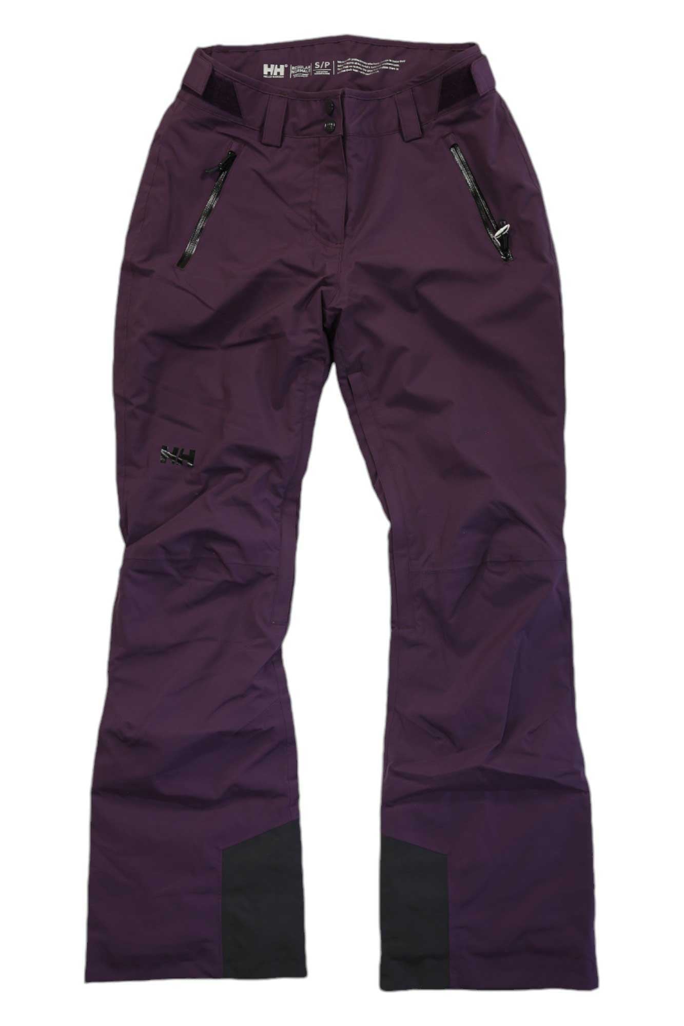 A pair of Helly Hansen Womens Legendary Insulated Pants in dark purple with black zipper pockets and reinforced black ankle fabric, laid flat on a white background.