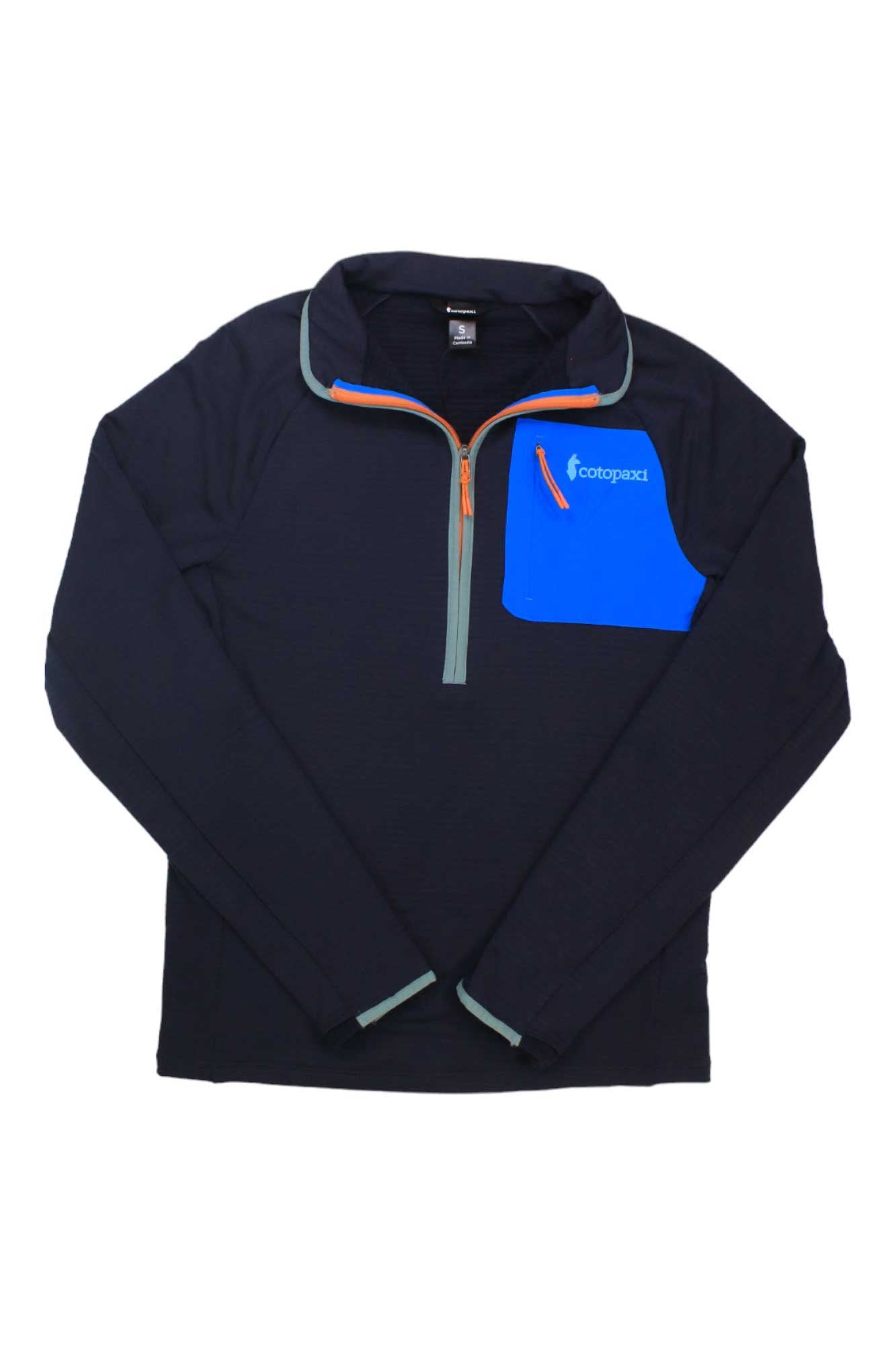 The Cotopaxi Otero Fleece Half-Zip Pullover is a black, long-sleeve top with a blue chest pocket, orange zipper, light gray accents, and Cotopaxi logo—ideal for hiking and made from recycled materials.