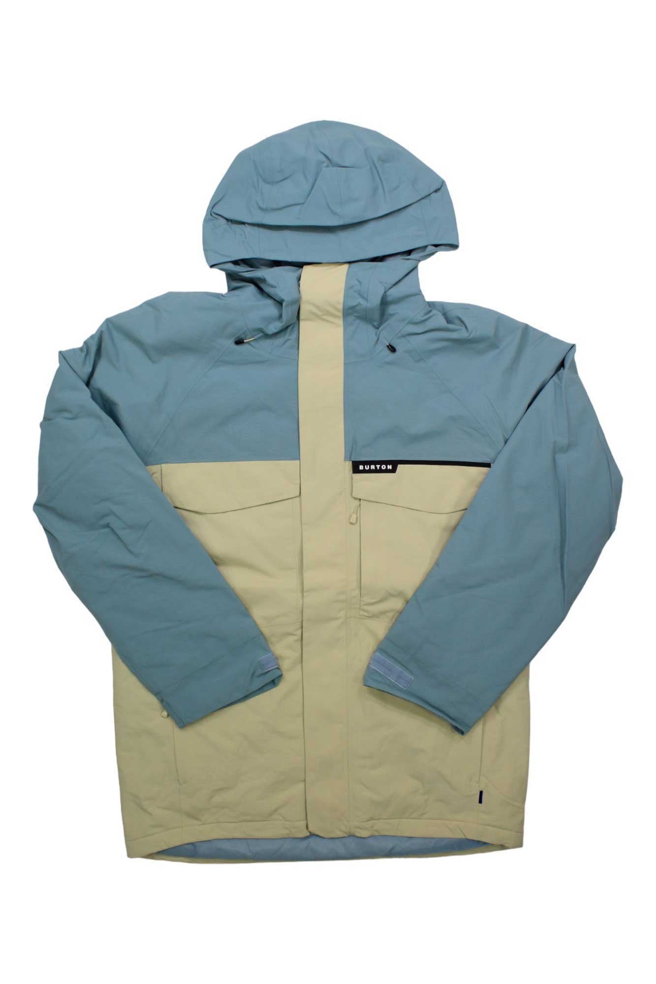 The Burton Men's Covert 2.0 Jacket features a two-tone design with light blue on the top and sleeves, beige on the lower half, a hood, full front zipper, chest flap pocket, and a small BURTON logo on the chest.