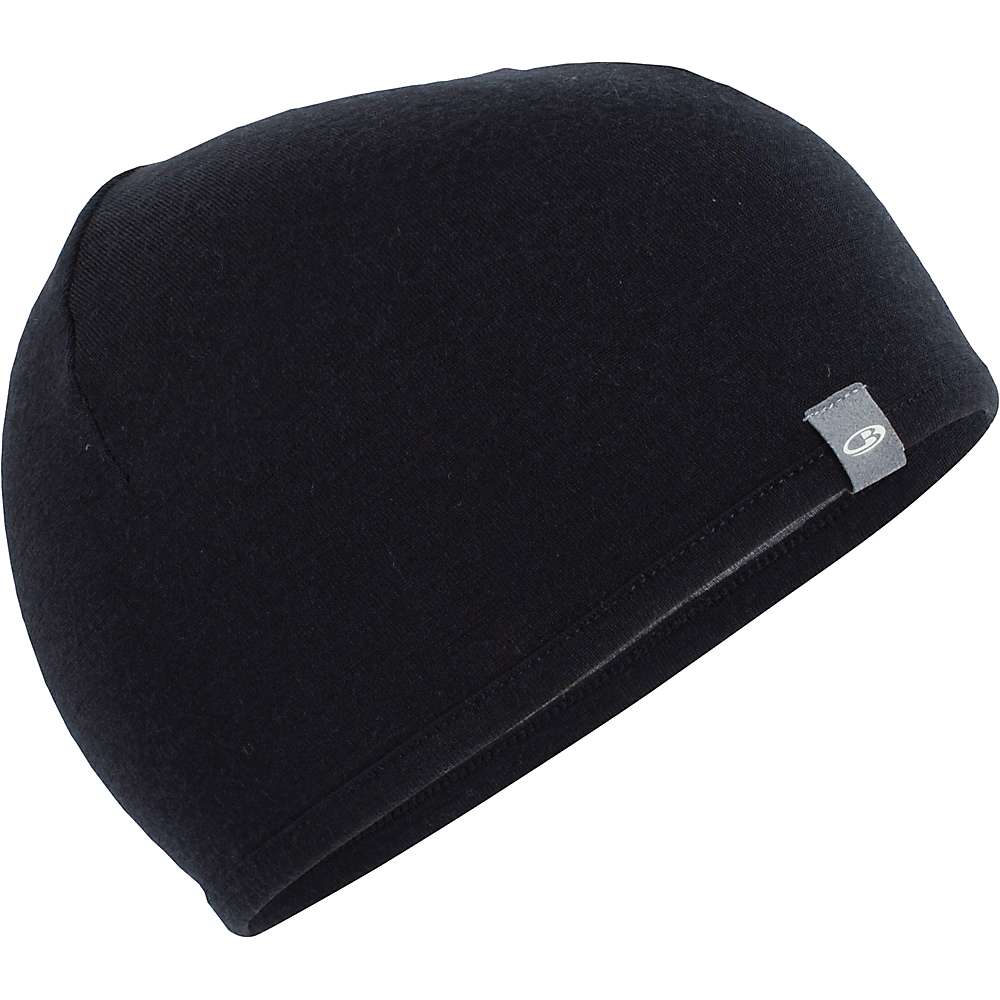 The Icebreaker Pocket Hat is a black merino wool beanie with a small gray tag and white logo on the edge, ideal for snowsports and shown against a white background.