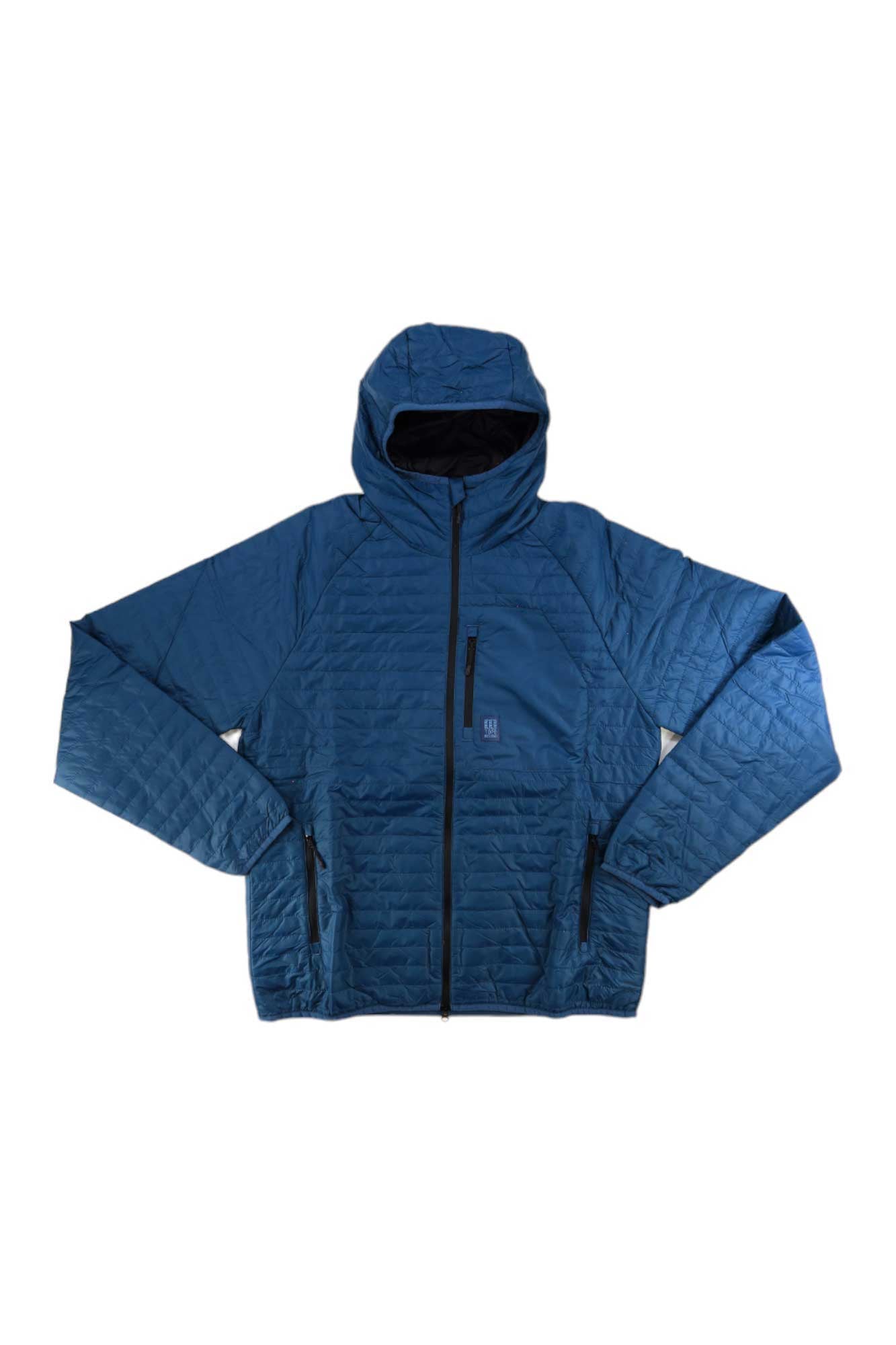 The Topo Designs Men's Global Puffer Hoodie in blue is quilted, packable, water resistant, and features a hood, front zipper, two side zip pockets, and a vertical chest zip pocket. Displayed on a white background.