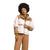 A woman with short curly hair wears The North Face Womens Cragmont Fleece Jacket over a green hoodie and tan pants, standing against a plain white background.
