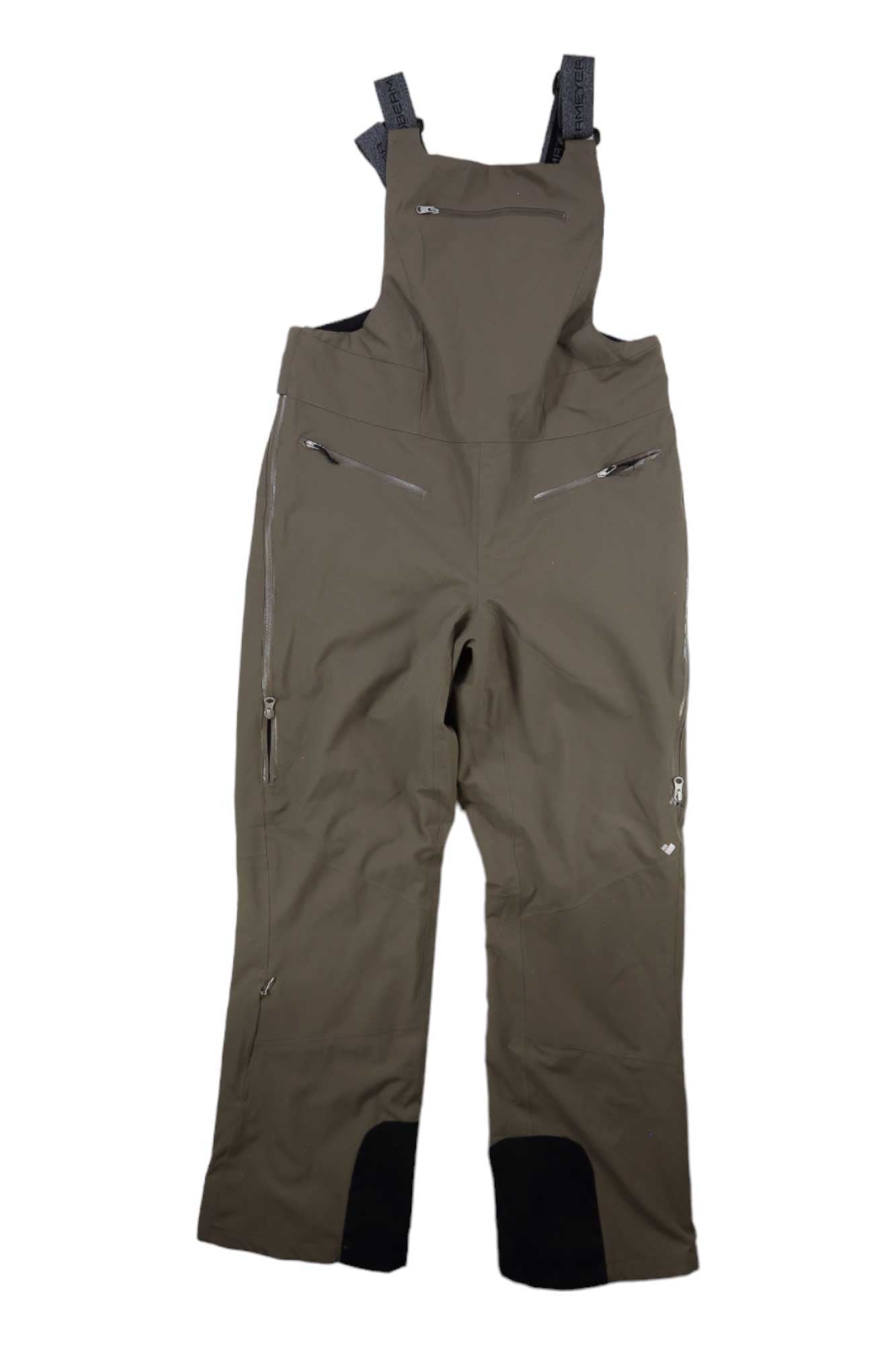 The Obermeyer Womens Bliss Bib Pant, shown flat on a white background, features olive green insulated bib-style ski pants with black adjustable straps, multiple zippered pockets, and reinforced black fabric at the inner ankles.
