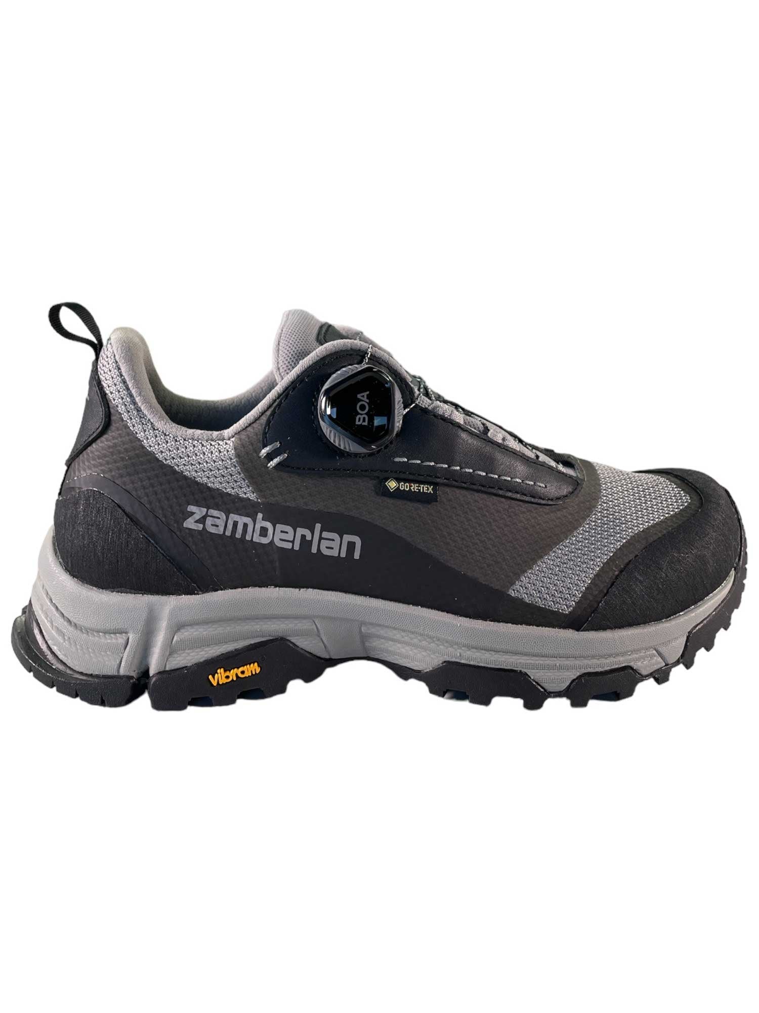 A side view of the Zamberlan Women's 167 Jane GTX Boa Shoe, a gray and black waterproof hiking shoe featuring mesh panels, a Vibram sole, and a BOA Fit System dial closure.