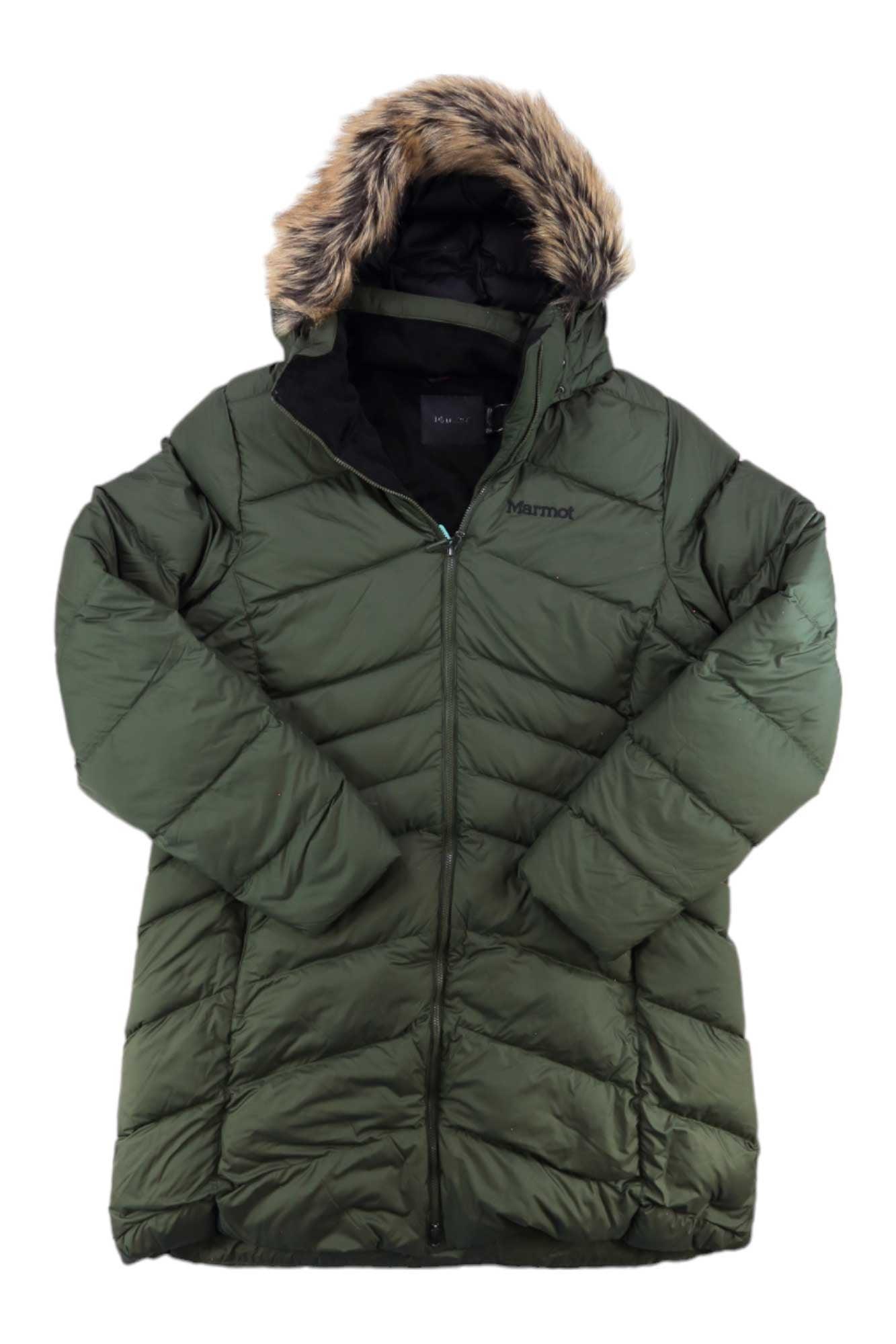 The Marmot Womens Montreal Down Coat is a green, quilted winter jacket with a front zipper, brown faux fur-trimmed hood, water-resistant fabric, and the Marmot logo on the chest.