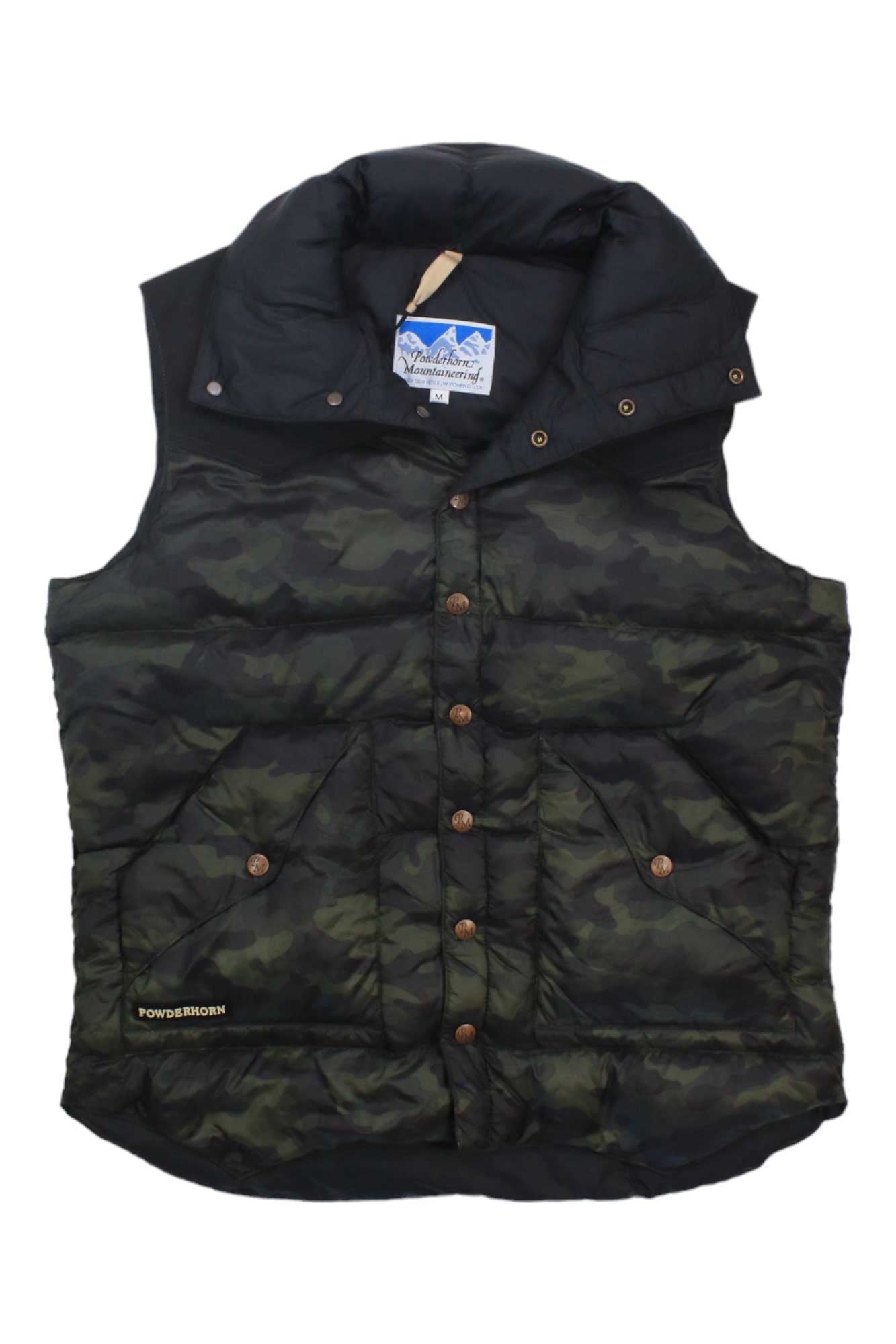 The Powderhorn Men's The Original Vest is a sleeveless, down insulated vest in dark green camo with brown buttons and a high collar. Made from recycled polyester, it features a Powderhorn label on the lower left and an inner collar logo tag.