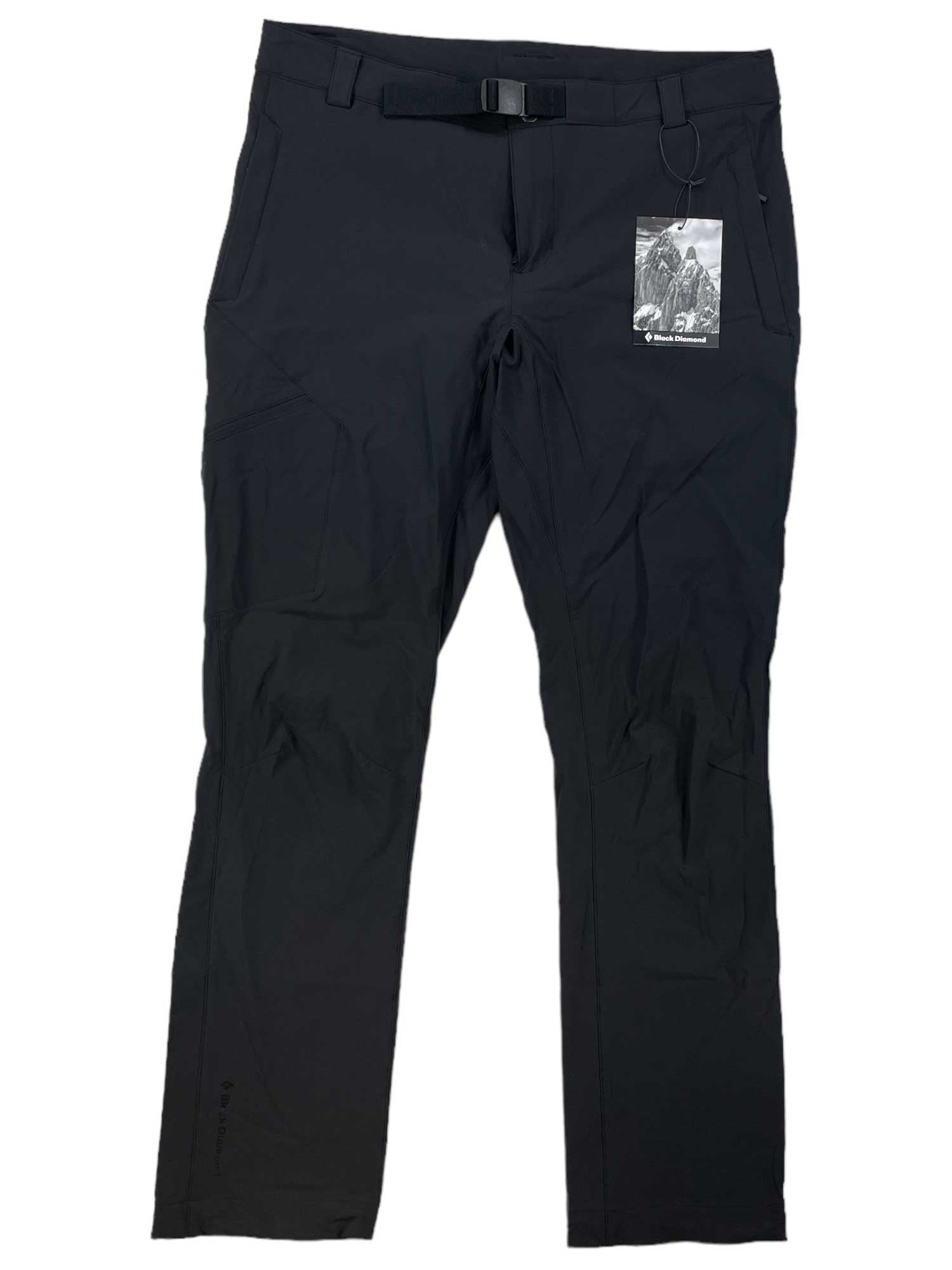 A Black Diamond Women's Alpine Pant in black, featuring a built-in belt, two front pockets, four-way stretch, and a tag on the right belt loop. The hiking pants are laid flat on a white background.