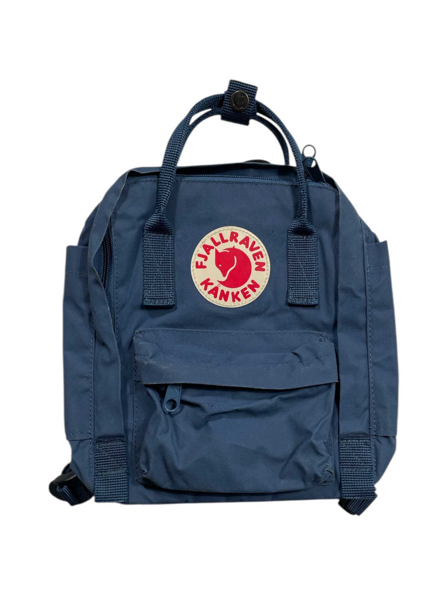 A dark blue, water-resistant Fjallraven Kanken Mini backpack with a front pocket, top handles, adjustable shoulder straps, and a round red-and-white logo patch on the front. The bag is shown against a plain white background.