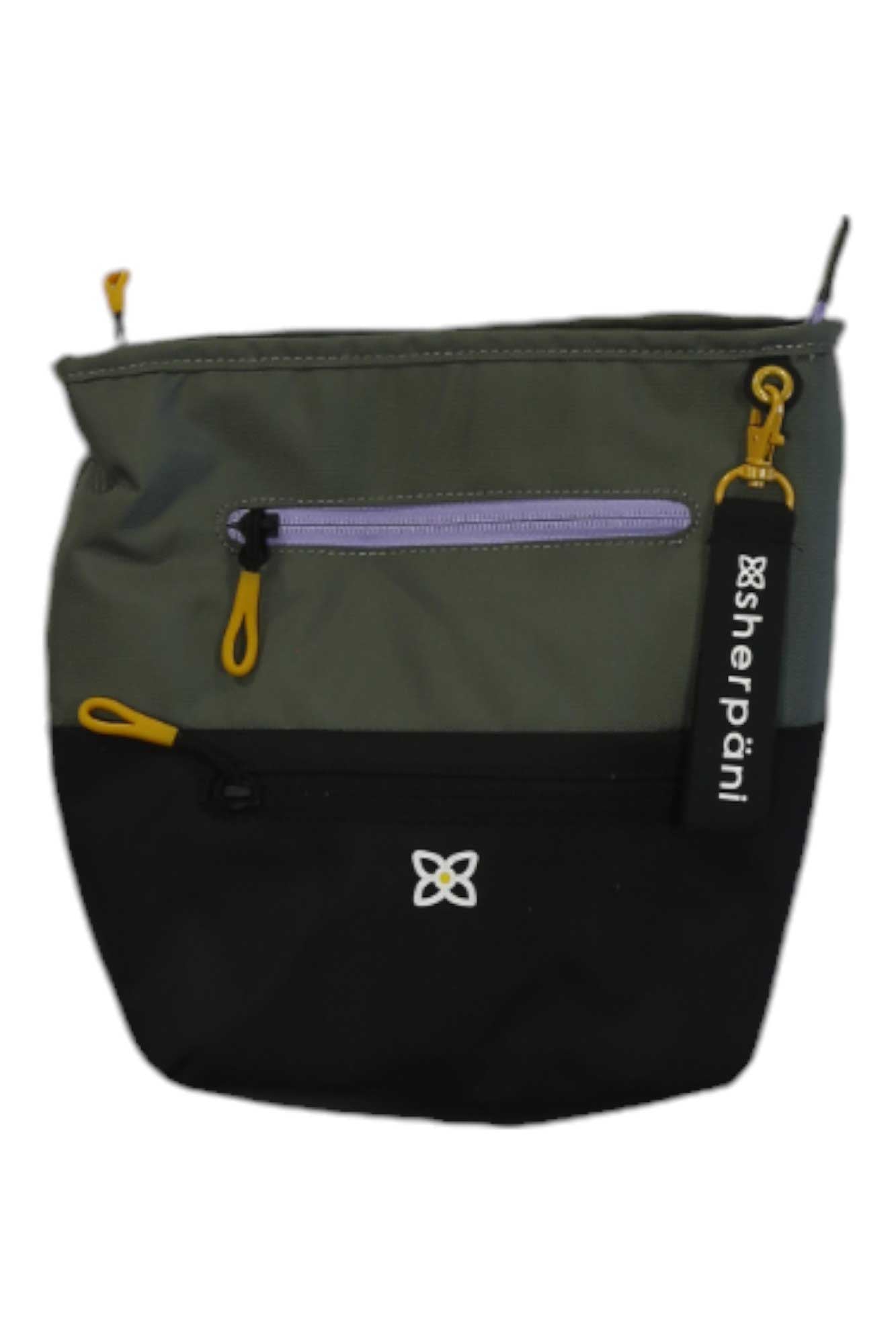 The Sherpani Women's Sadie Cross Body Bag is a small, two-tone bag made from recycled materials, featuring an olive green upper half, black lower half, front pocket, yellow and purple zippers, and a Sherpani keychain tag.