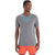A man faces slightly to the side, wearing the Icebreaker Men's Sphere II SS Tee in grey with blue and red accents and orange shorts, looking off to the right against a plain white background.