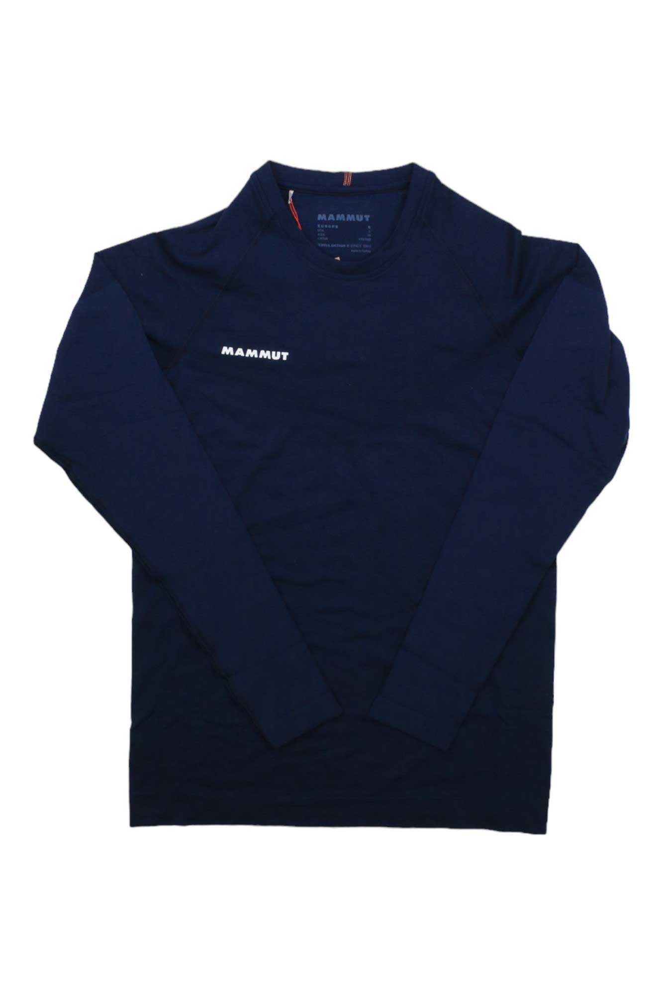The Mammut Mens Trift Longsleeve Shirt is a seamless, navy blue hiking top featuring "MAMMUT" in white on the left chest, shown flat against a white background.