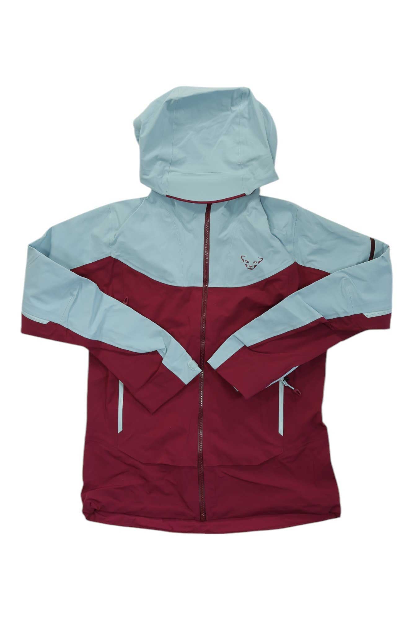 The Dynafit Womens Beast Hybrid Jacket features a maroon body with light blue helmet-compatible hood, sleeves, and shoulders. It includes a front zipper, zippered pockets, and a small chest logo. Perfect for outdoor waterproof protection.