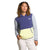 A person with curly hair, wearing The North Face Womens Mountain Sweatshirt Pullover in color-blocked blue, light gray, and yellow, stands with one hand in the front pocket and a neutral expression against a white background.