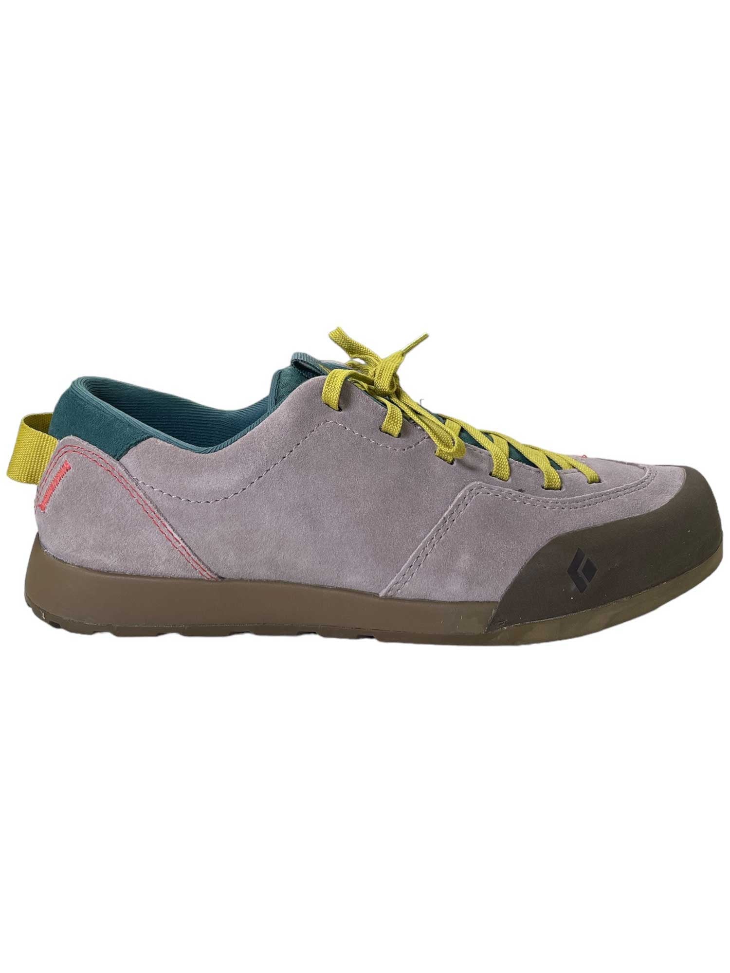 The Black Diamond Women's Prime Shoe is a gray suede climbing sneaker with yellow laces, green lining, brown sole, red stitching, yellow heel pull tab, and a small black logo by the toe.