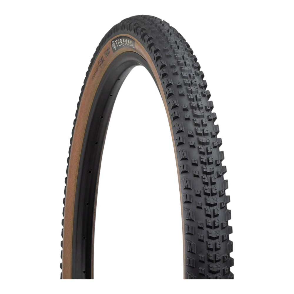 The Teravail Ehline Tire - 29in is shown upright on a white background, featuring a black tread with tan sidewalls and evenly spaced knobs.