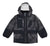 The Obermeyer Boys Nebula Jacket features a black and gray geometric dotted pattern, hood, front zipper, multiple pockets, and elastic cuffs. This insulated winter jacket keeps active boys warm and stylish through cold months.