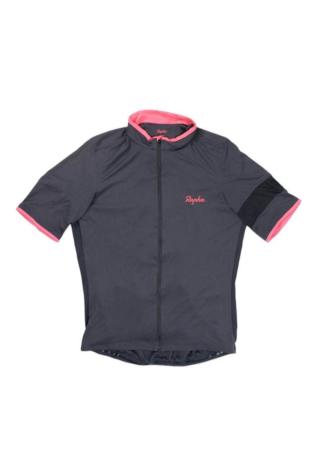 The Rapha Mens Super Lightweight Jersey is a short-sleeved, dark gray cycling top featuring a front zipper, pink trim on the collar and sleeve ends, plus the Rapha logo on the chest.