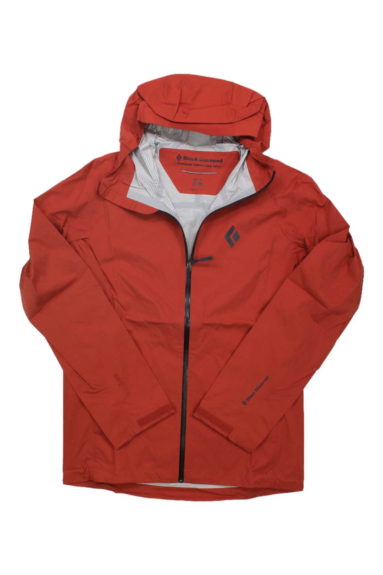 The Black Diamond Mens StormLine Stretch Rain Shell is a red men’s rain jacket with a hood, black front zipper, and small black logo on the left chest. Made from stretch shell fabric, it’s waterproof and shown flat with hood up and sleeves spread out.