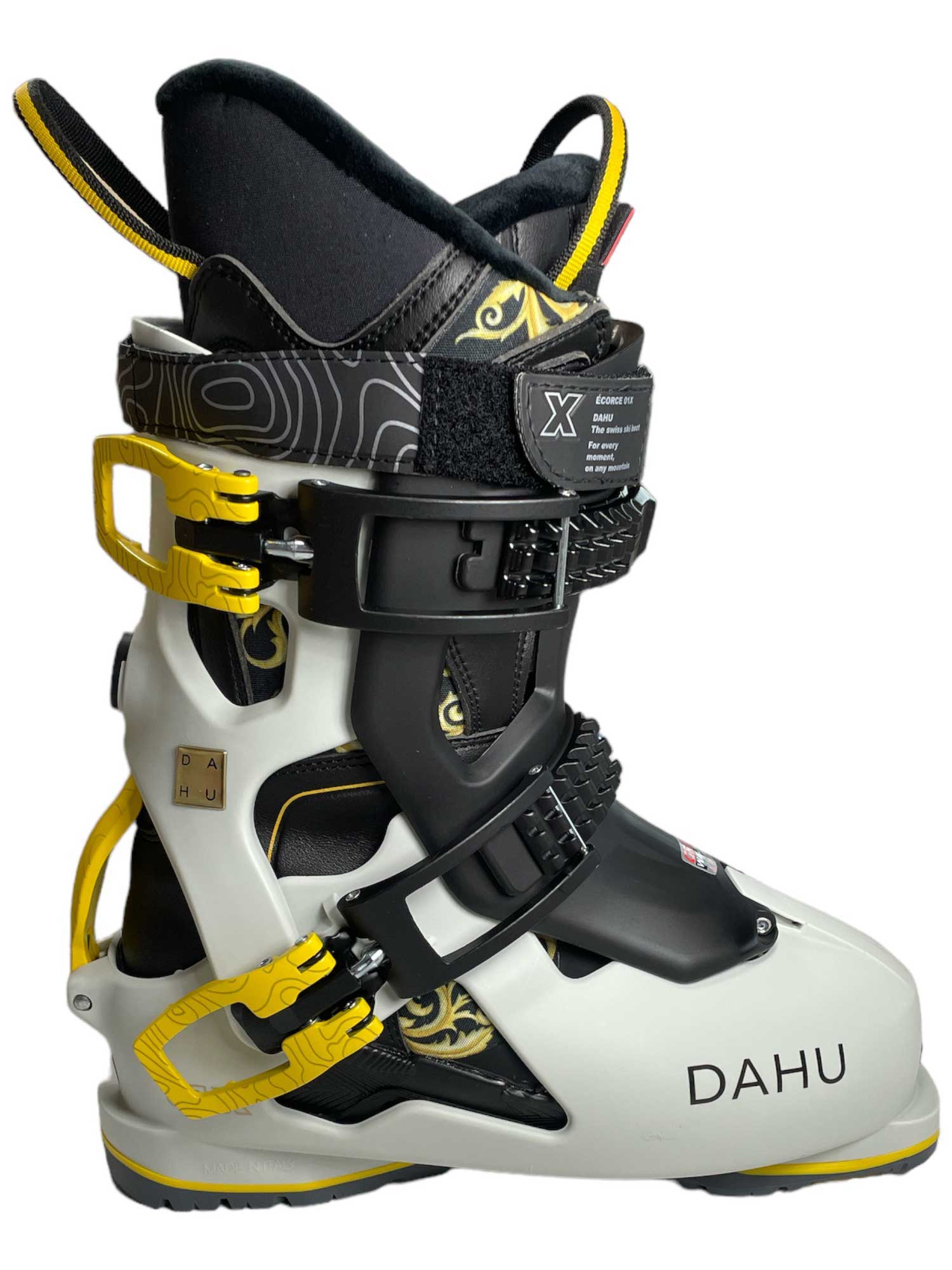 The Dahu Womens Ecorce 01 X Limited Edition W90 Flex Ski Boot is a white and black all-mountain alpine boot with yellow buckles, a high cuff, adjustable straps, and ergonomic padding for comfort and performance.