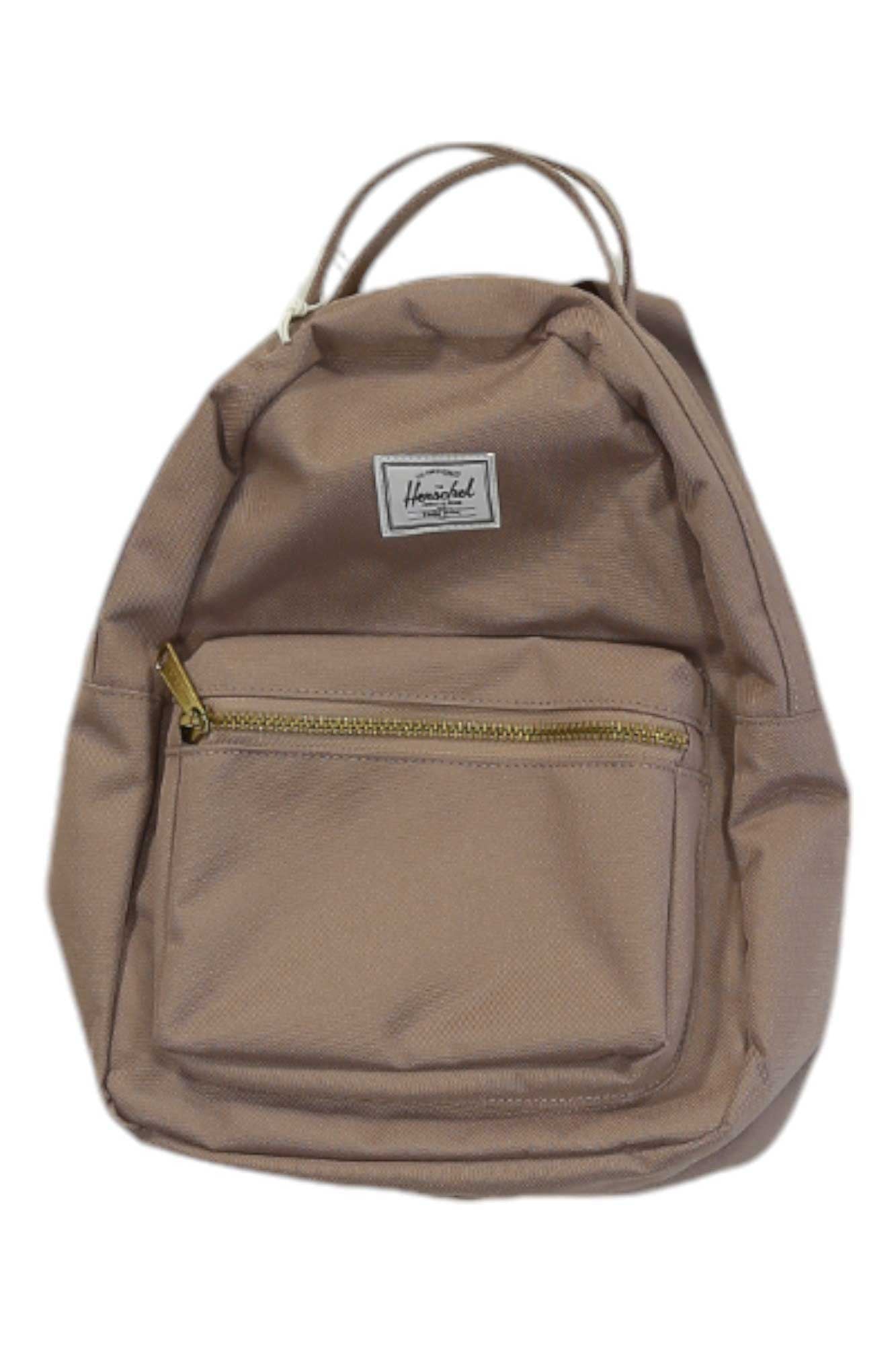 The Herschel Supply Co Nova Mini Backpack is light brown with adjustable shoulder straps, a front zippered pocket, metal zippers, a striped liner, two short top handles, and features a small white rectangular Herschel label.