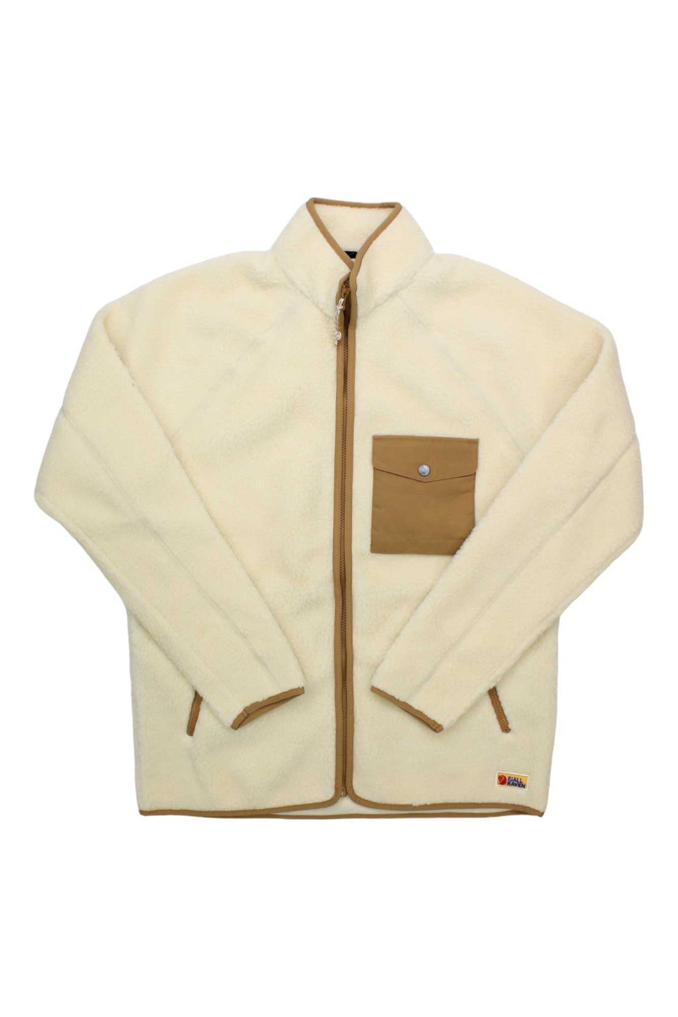 The Fjallraven Men's Vardag Pile Fleece Jacket features a cream color with light brown trim, a stand-up collar, brown front zipper, and snap-button chest pocket. Made from recycled polyester, it’s a warm, simple mid-layer for casual wear.