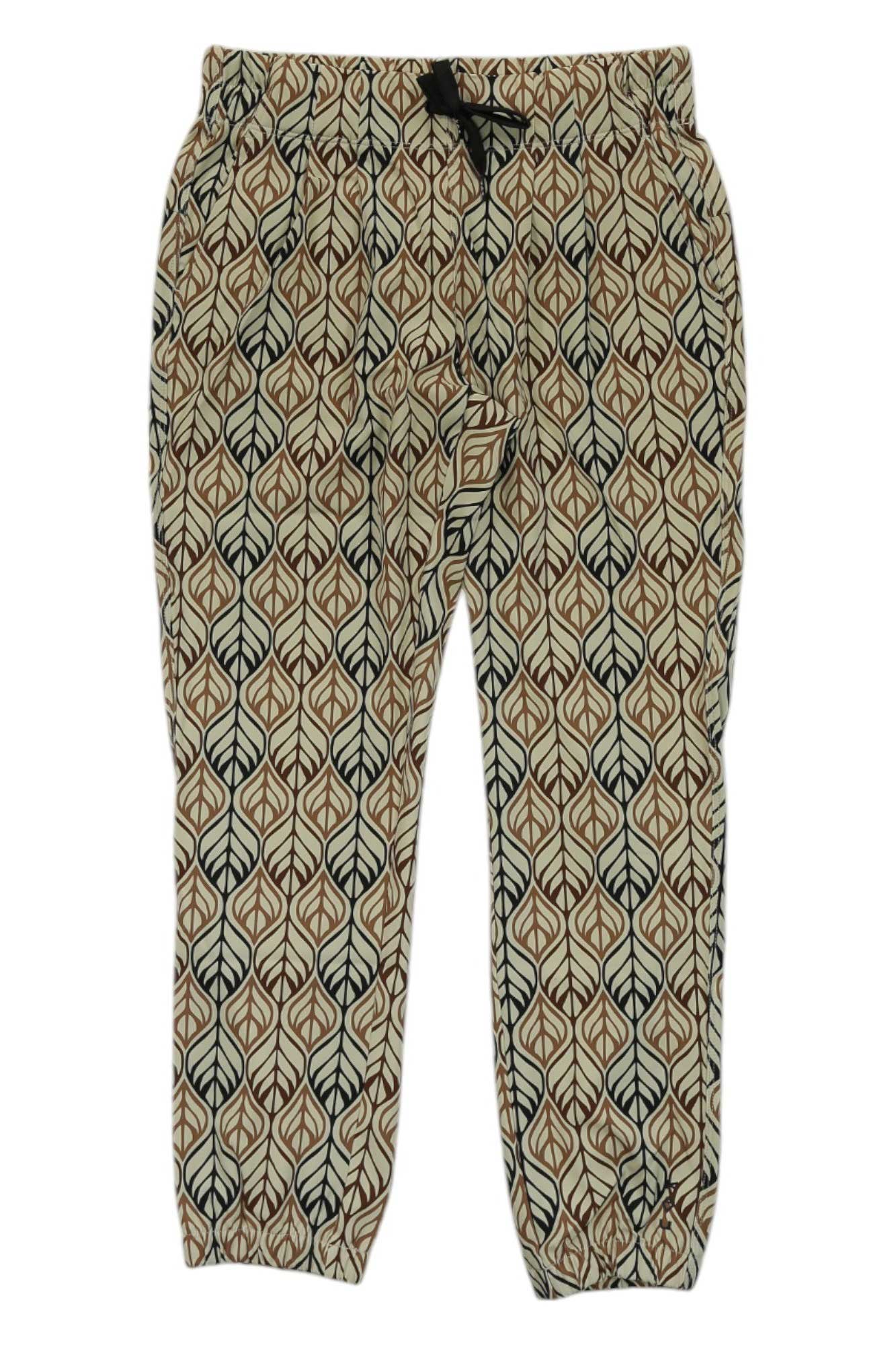 The KAVU Womens Bucerias Pant is a pair of beige quick-drying pants with an elastic waist and cuffs, decorated with a repeating brown and black leaf pattern—ideal for your next outdoor adventure.