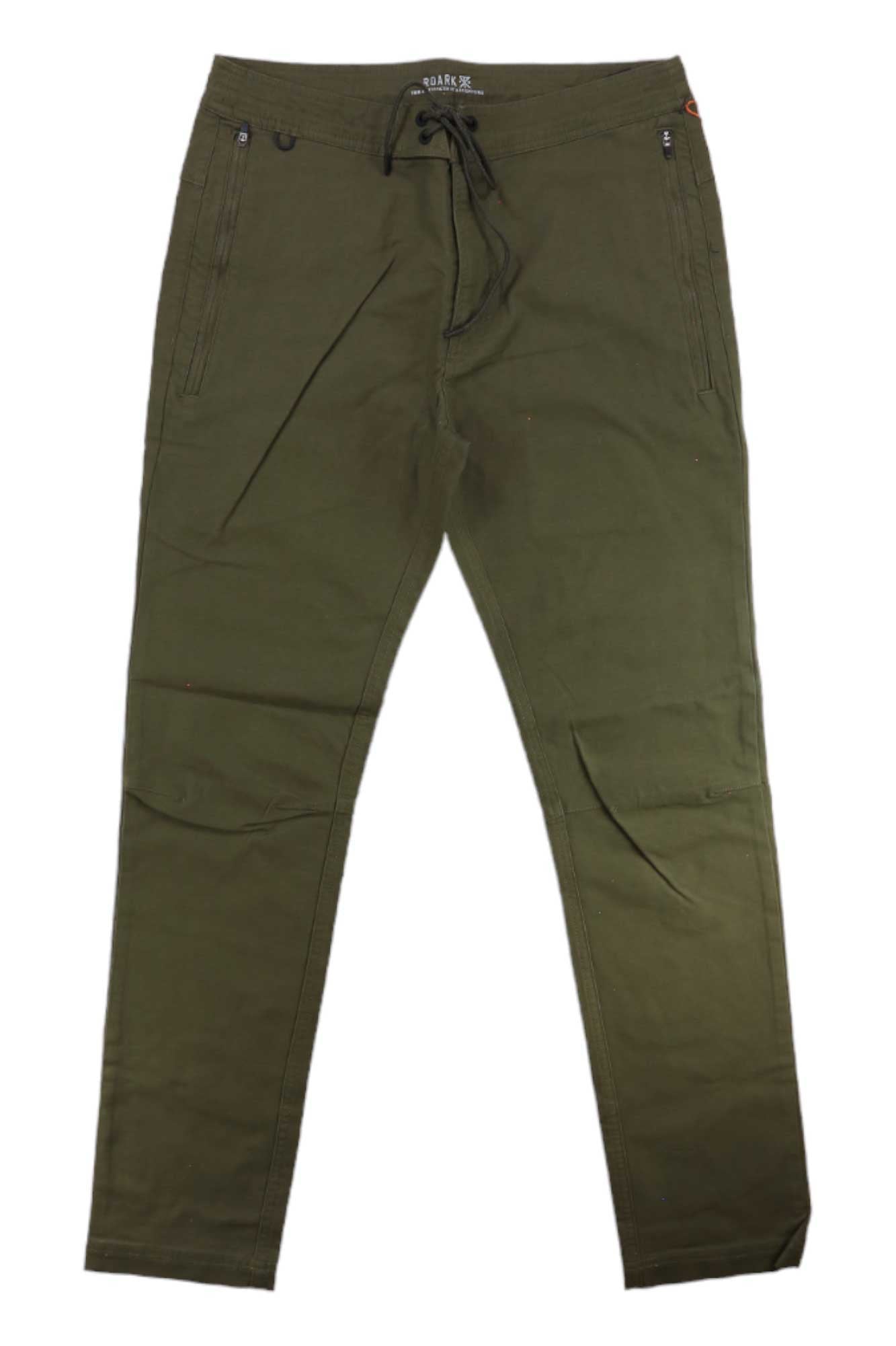 The Roark Men's The Layover 2.0 Pant in olive green features stretch canvas, a slim fit, elastic waistband with drawstring, and side zipper pockets—laid flat on white background. Perfect travel pants combining comfort and style.
