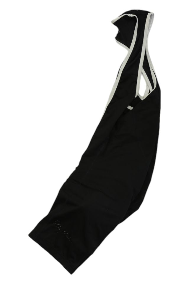 A pair of Mens Bib Shorts in black with white straps, laid flat on a white background—ideal for cyclists seeking high-quality men's cycling apparel.